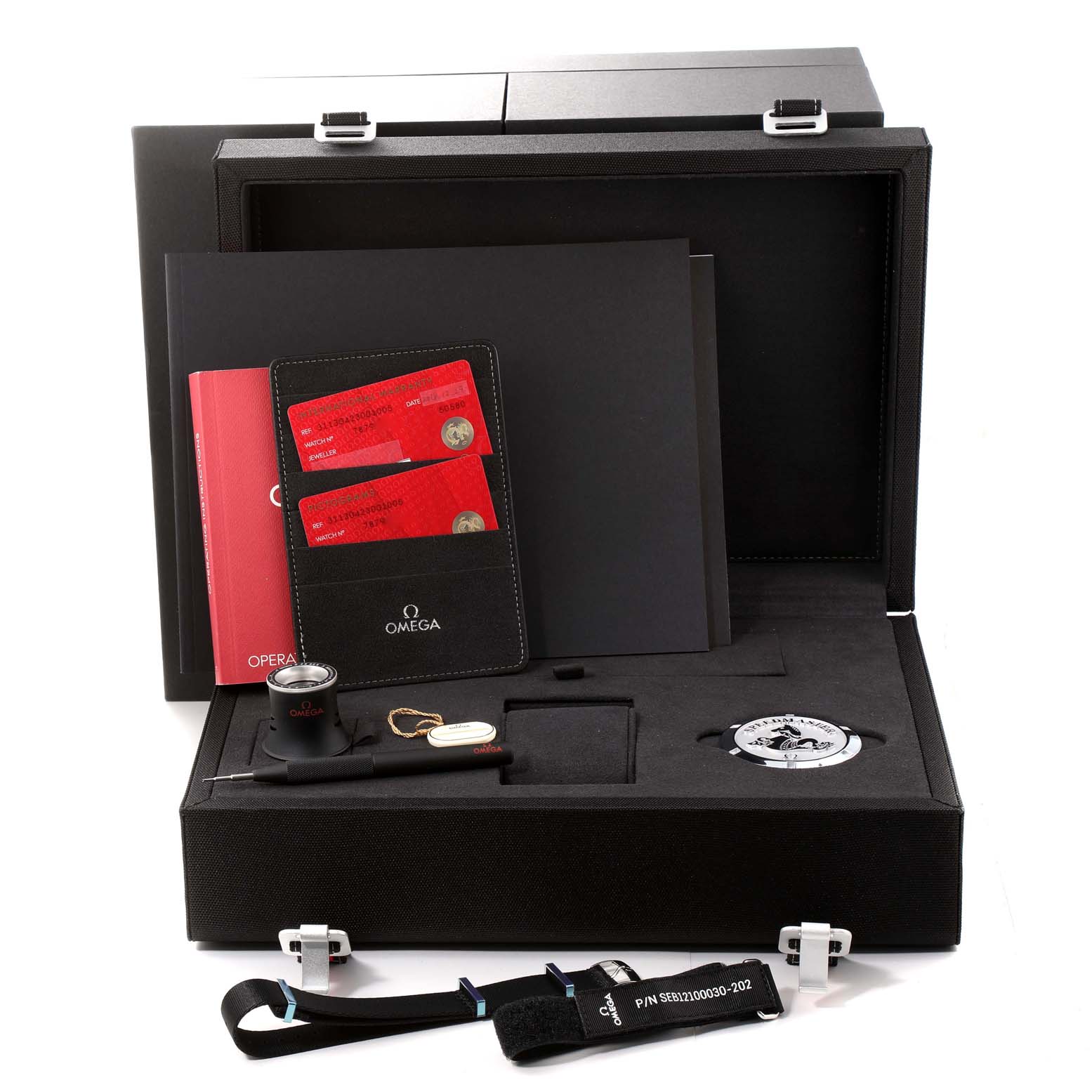 The image shows an Omega Speedmaster 311.30.42.30.01.005 Men
s Stainless Steel Black Dial 311.30.42.30.01.005 Men
s Stainless Steel Black Dial watch box with its accessories, including a loupe, strap, tool, and documents.