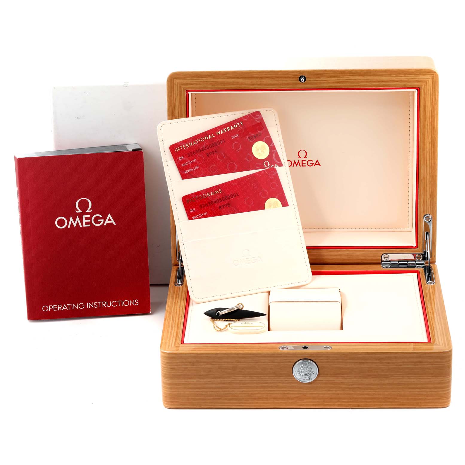 This image shows an open box of an Omega Speedmaster 326.30.40.50.03.001 Men
s Stainless Steel Blue Dial 326.30.40.50.03.001 Men
s Stainless Steel Blue Dial watch with warranty cards, operating instructions, and accessories.