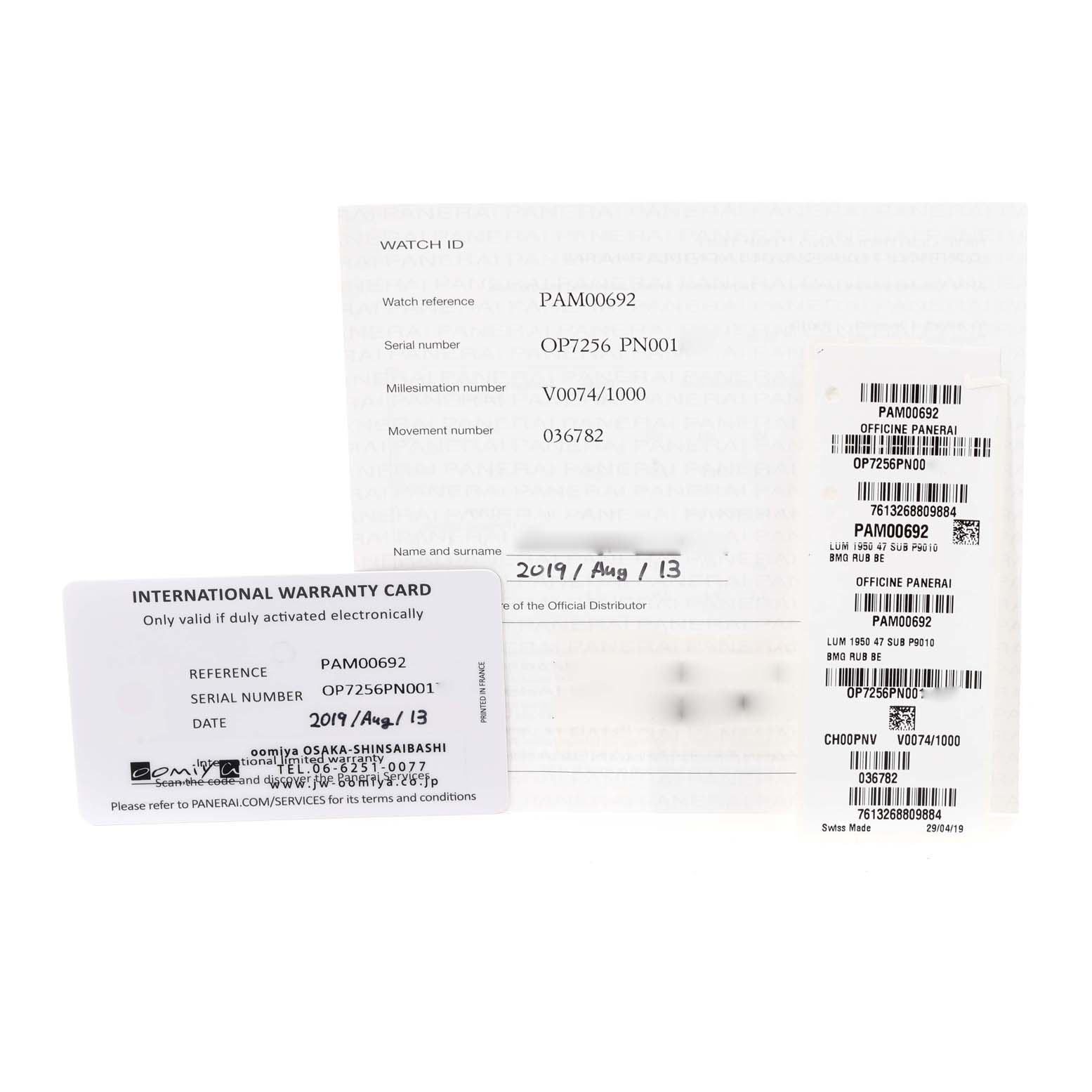 The image shows warranty cards and informational documents for a Panerai Submersible PAM00692 Men
s Ceramic Blue Dial PAM00692 Men
s Ceramic Blue Dial model watch.