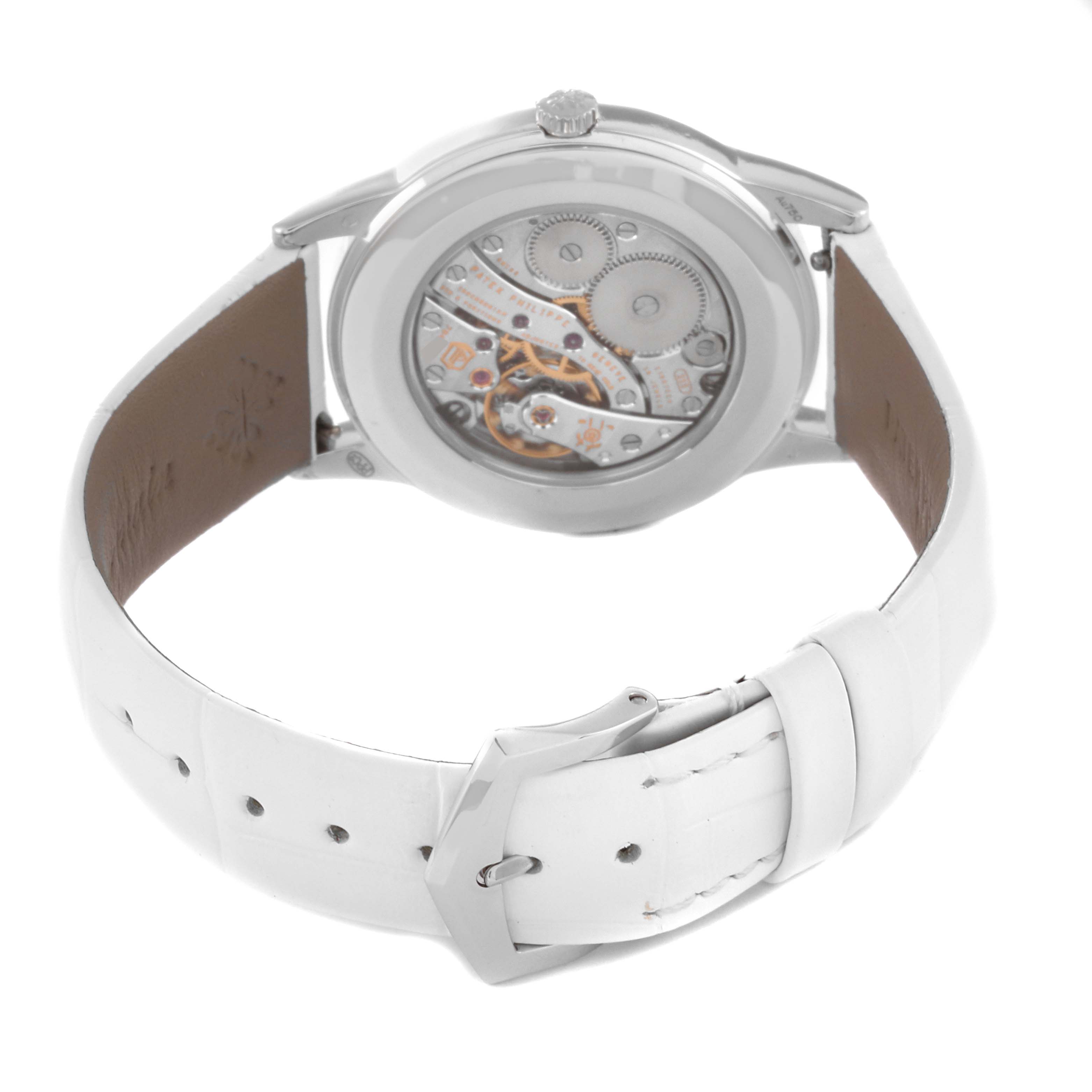 The image shows the back view of the Patek Philippe Calatrava 7122/200G Women's White Gold White Dial 7122/200G Women's White Gold White Dial watch, showcasing its movement and white leather strap.