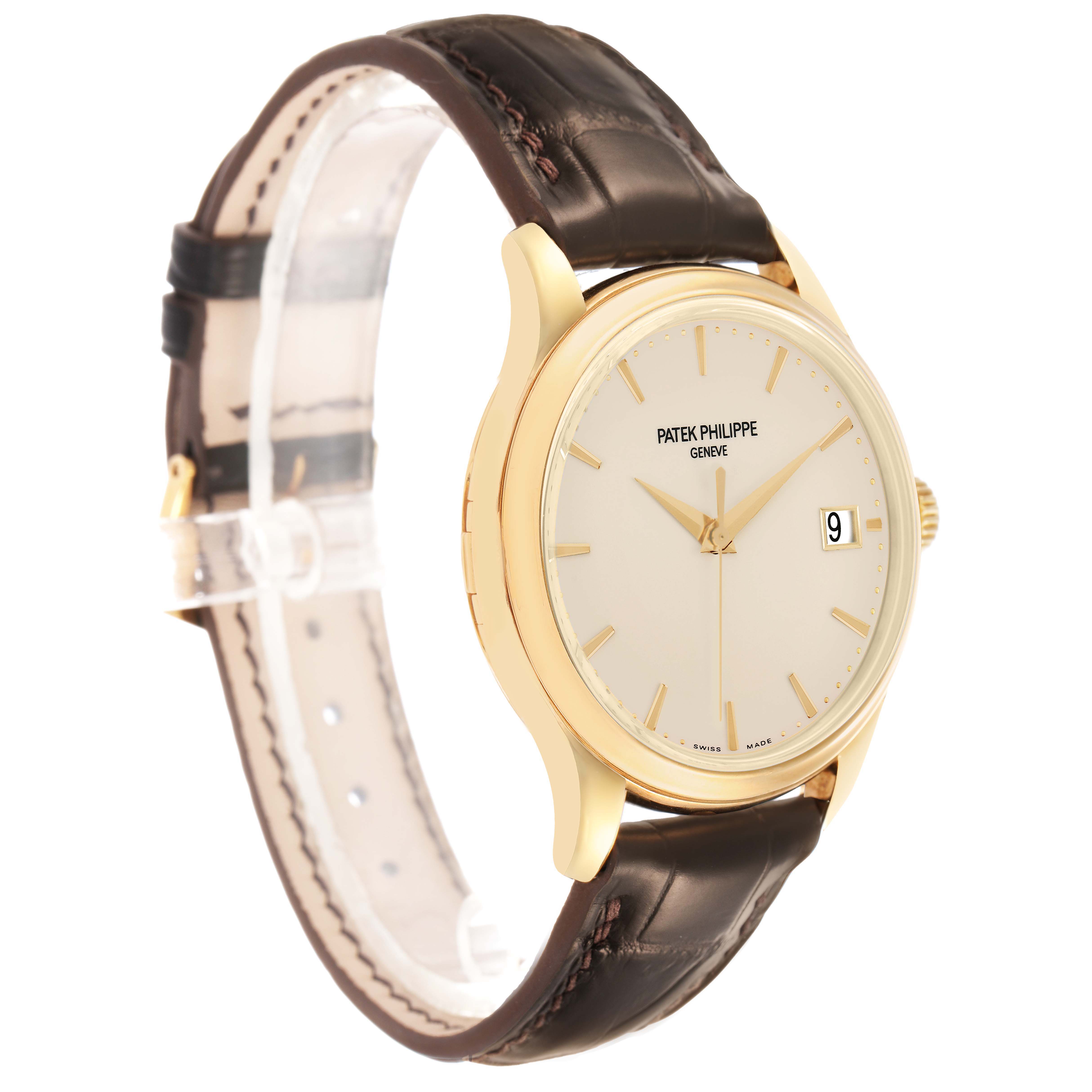 The Patek Philippe Calatrava 5227J Mens Yellow Gold White Dial watch is shown at a slight side angle, displaying its gold case, cream dial, and brown leather strap.