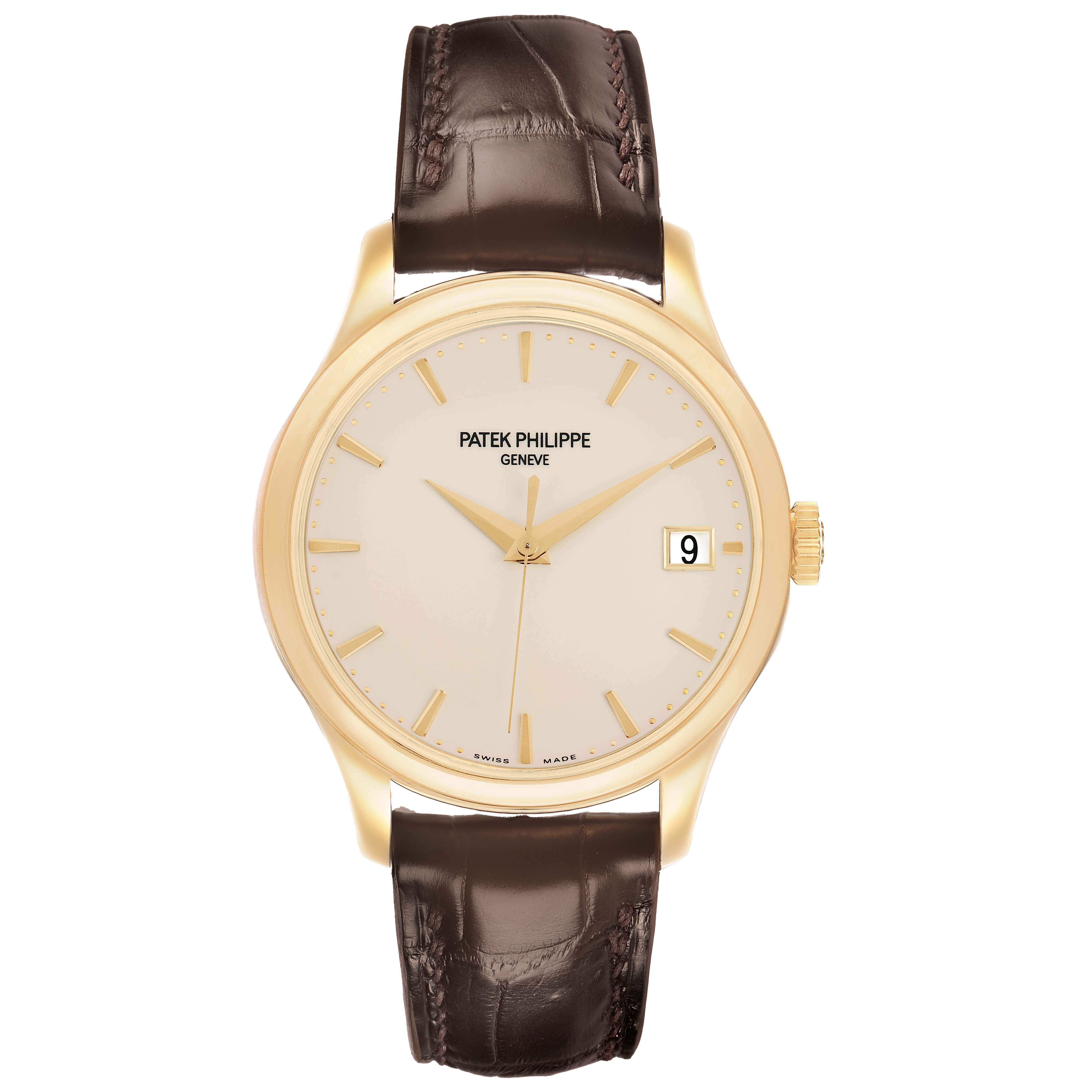 The Patek Philippe Calatrava 5227J Mens Yellow Gold White Dial watch is shown from a front angle, highlighting the dial, gold case, leather strap, and date window.