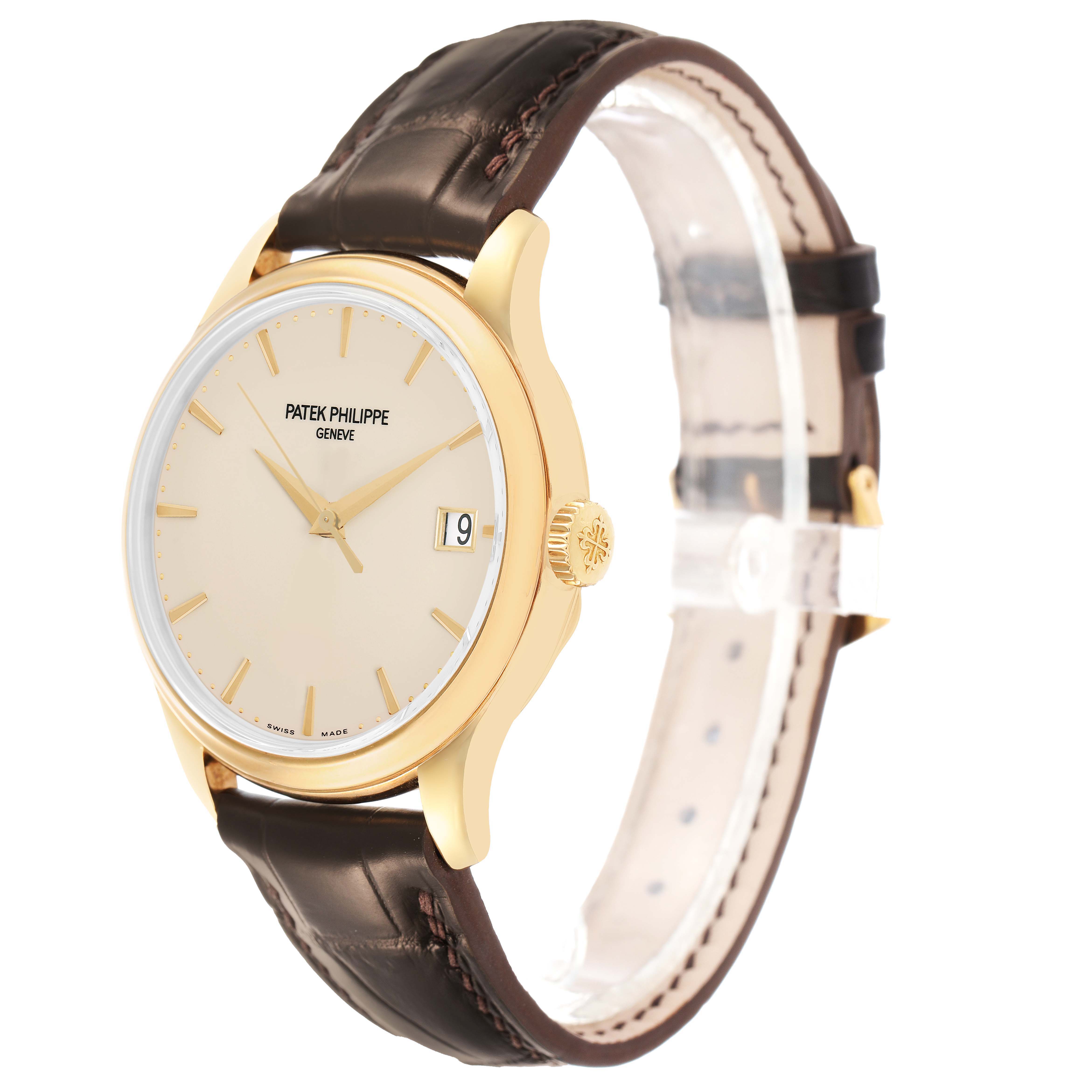The Patek Philippe Calatrava 5227J Men's Yellow Gold White Dial watch is shown at a three-quarter angle, highlighting the gold case, beige dial, leather strap, and crown.