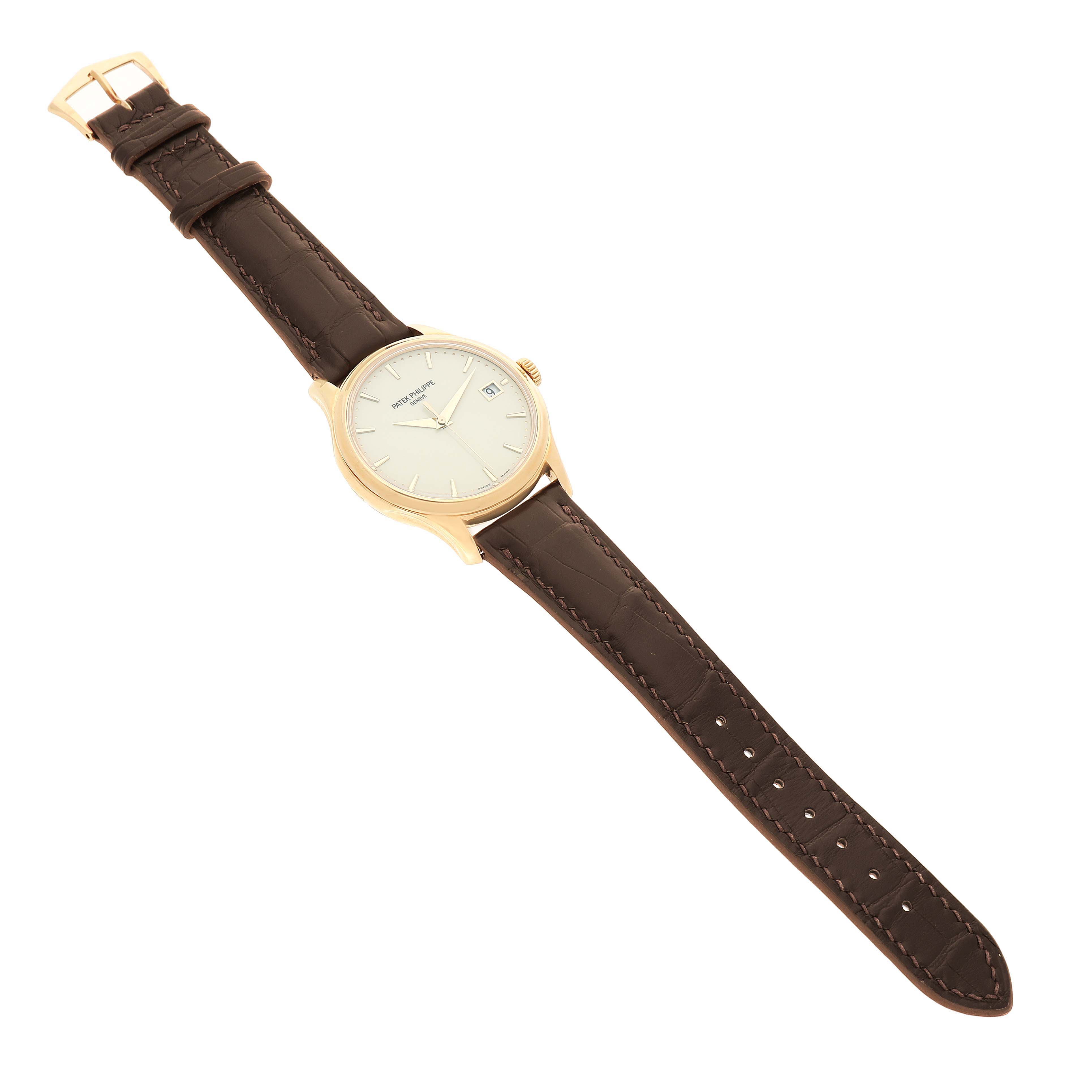 The Patek Philippe Calatrava 5227J Men's Yellow Gold White Dial watch is shown from a top-down angle, displaying the full face, leather strap, and buckle.