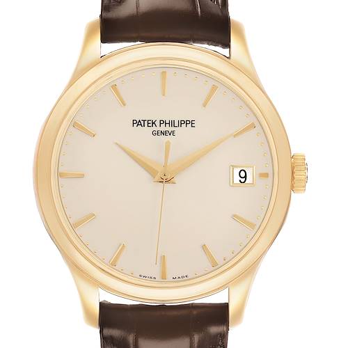 The image shows a front view of the Patek Philippe Calatrava 5227J Men's Yellow Gold White Dial, highlighting its dial, hands, date window, and brown leather strap.