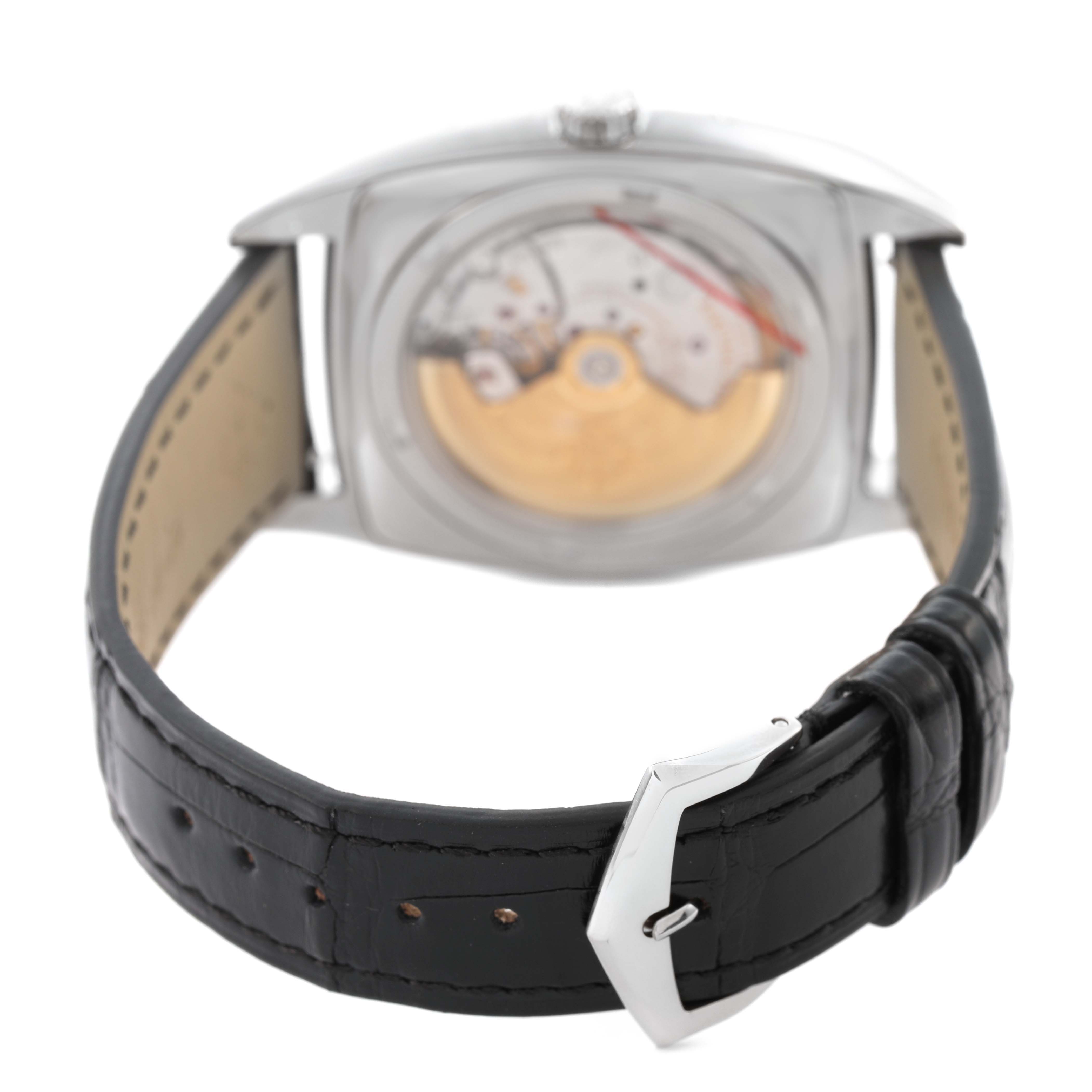 The Patek Philippe Gondolo 5135G-001 Men's White Gold Grey Dial watch is shown from the rear, highlighting the movement and leather strap with a buckle.