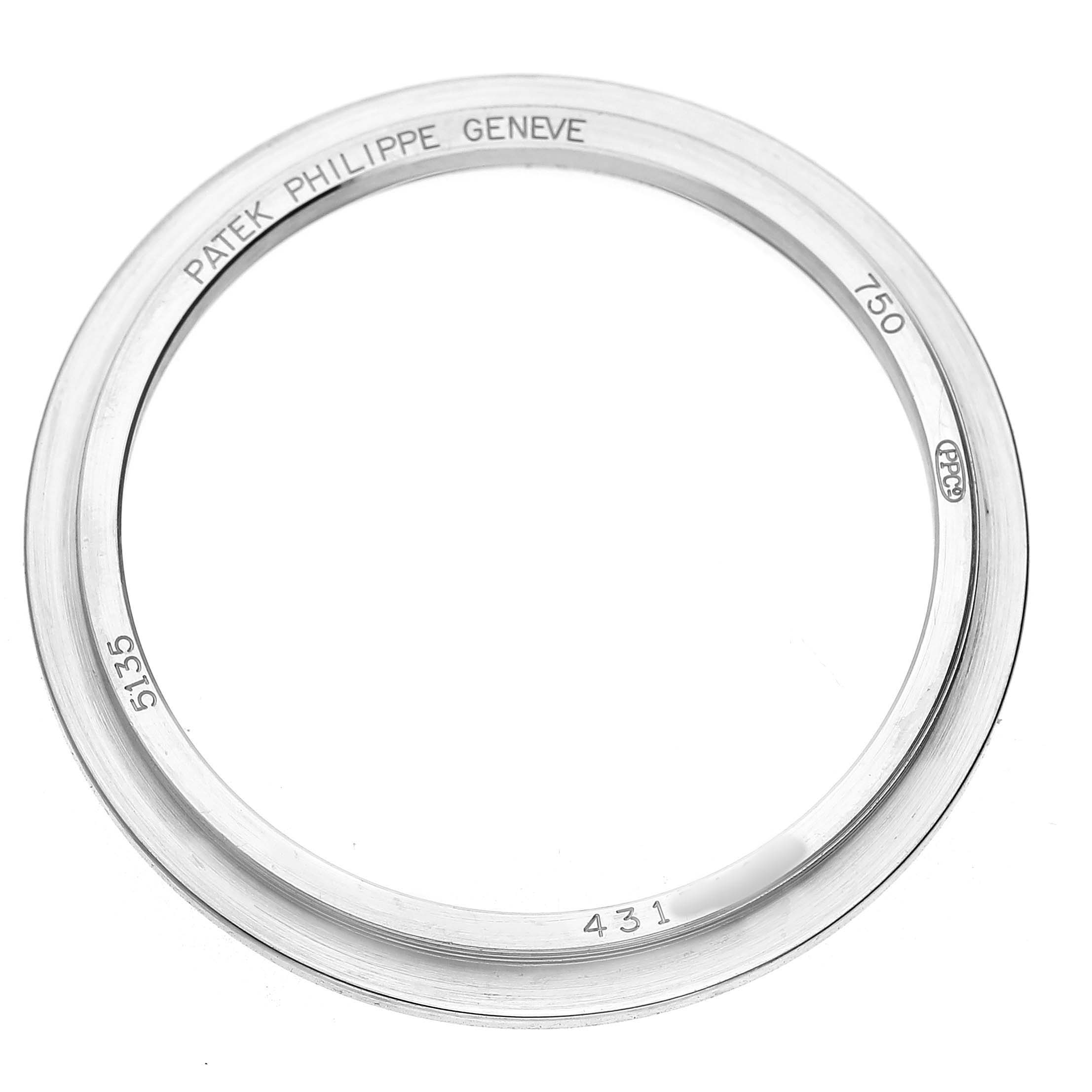This image shows a top view of a bezel for the Patek Philippe Gondolo 5135G-001 Men's White Gold Grey Dial, featuring engravings and markings.