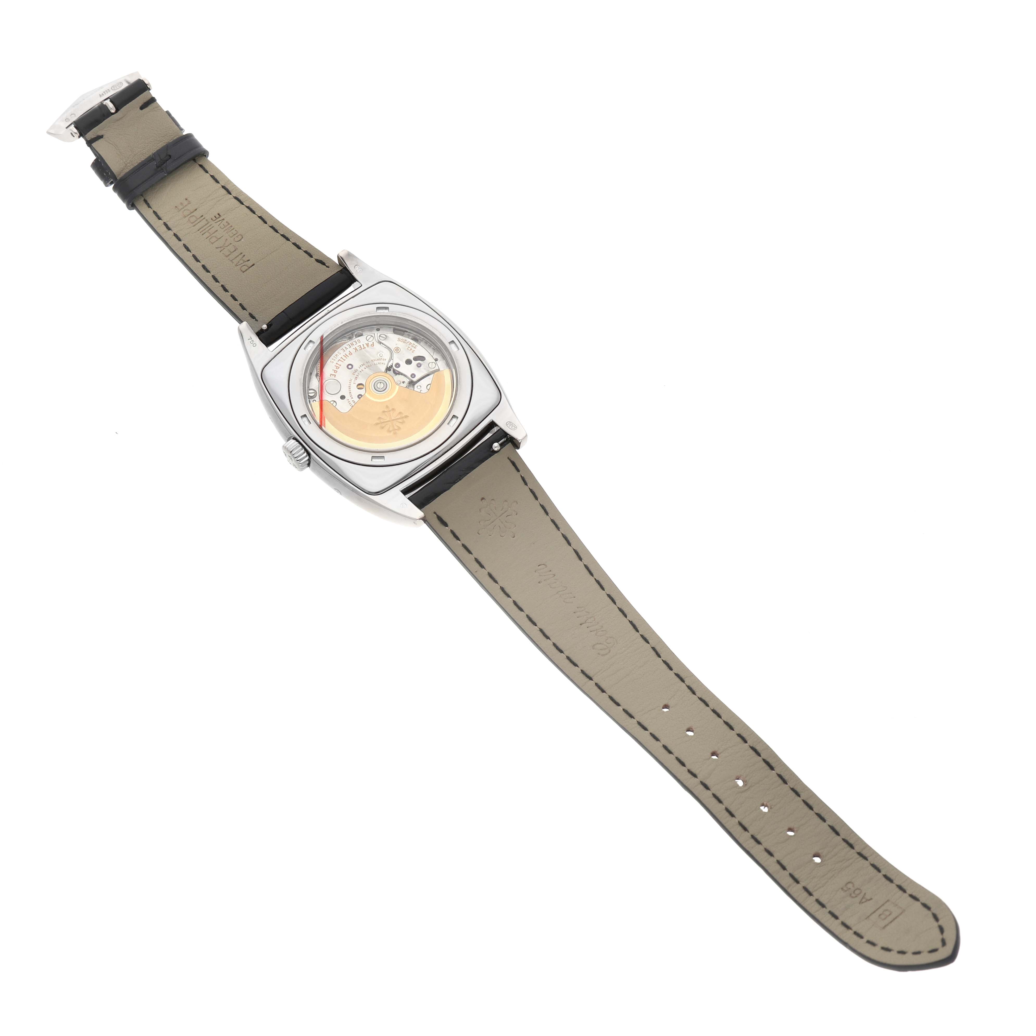 The image shows the backside of a Patek Philippe Gondolo 5135G-001 Men's White Gold Grey Dial watch, highlighting its movement and leather strap.