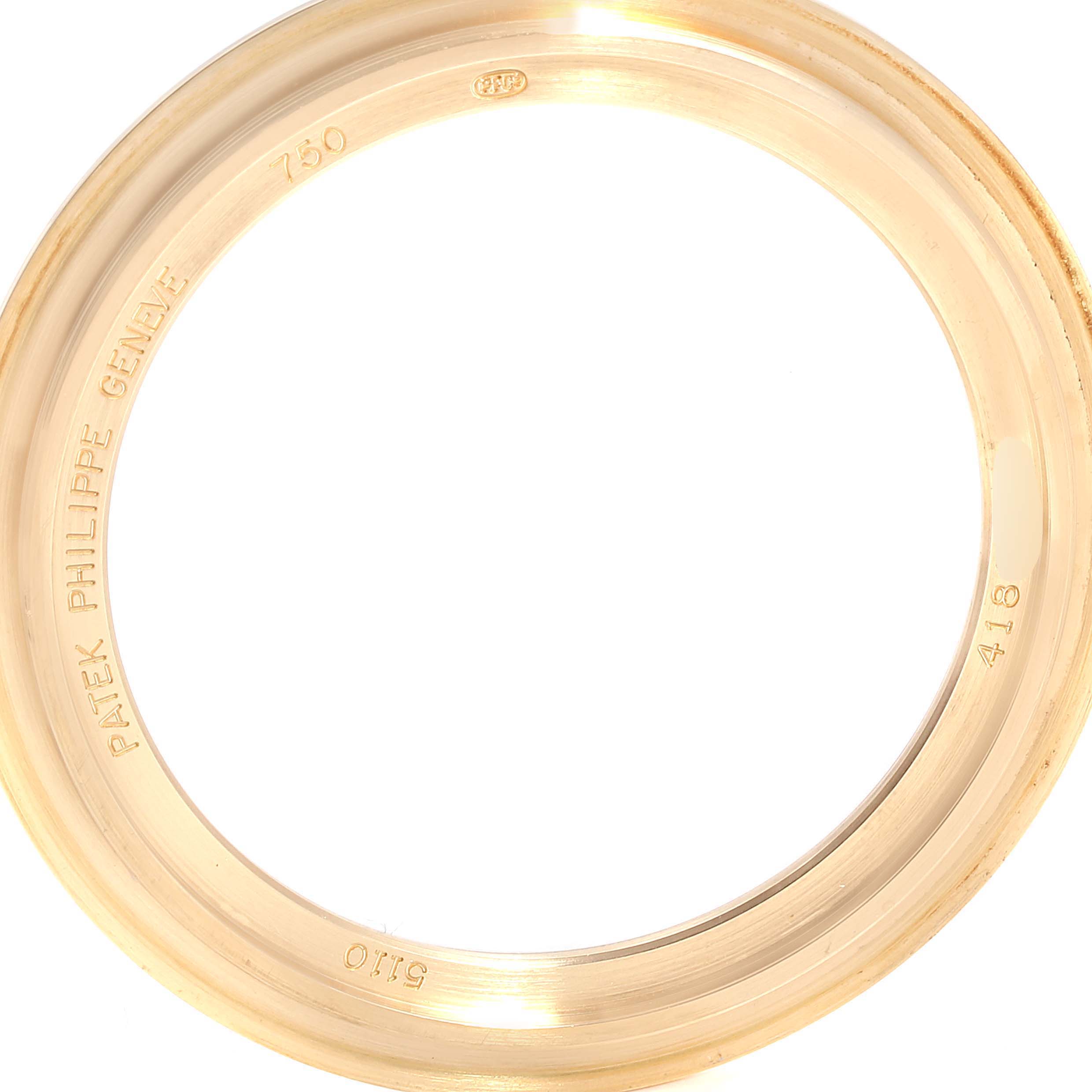 The image shows a close-up of the bezel ring from a Patek Philippe Complications 5110J Men's Yellow Gold Silver Dial 5110J Men's Yellow Gold Silver Dial model watch.