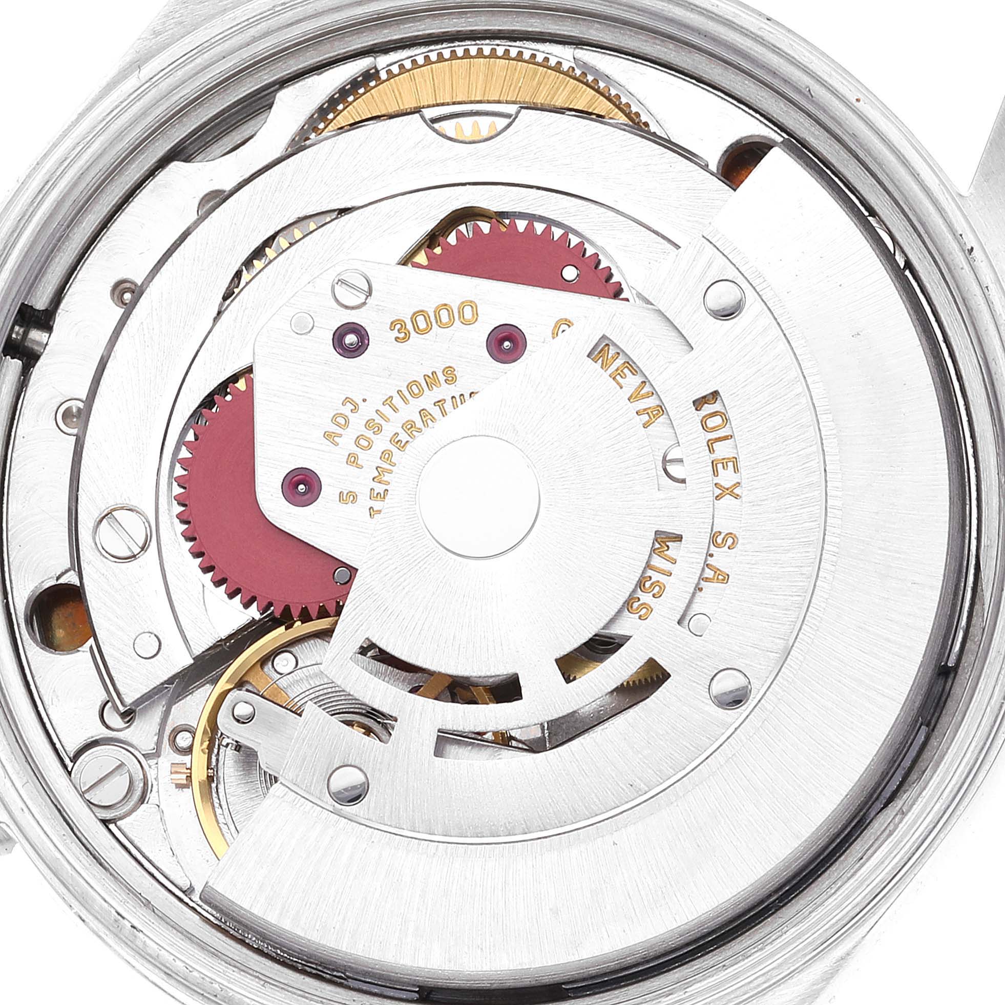 The image shows a close-up view of the inner mechanism of a Rolex Air-King 14000 Men's Stainless Steel Blue Dial 14000 Men's Stainless Steel Blue Dial watch, highlighting gears and components.