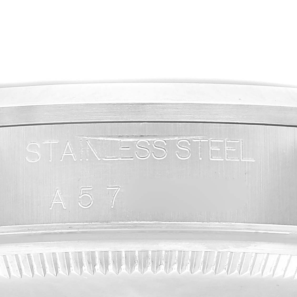 This is a close-up shot of the case back engraving on a Rolex Air-King 14000 Men's Stainless Steel Blue Dial 14000 Men's Stainless Steel Blue Dial, showing "STAINLESS STEEL" and a partial serial number.