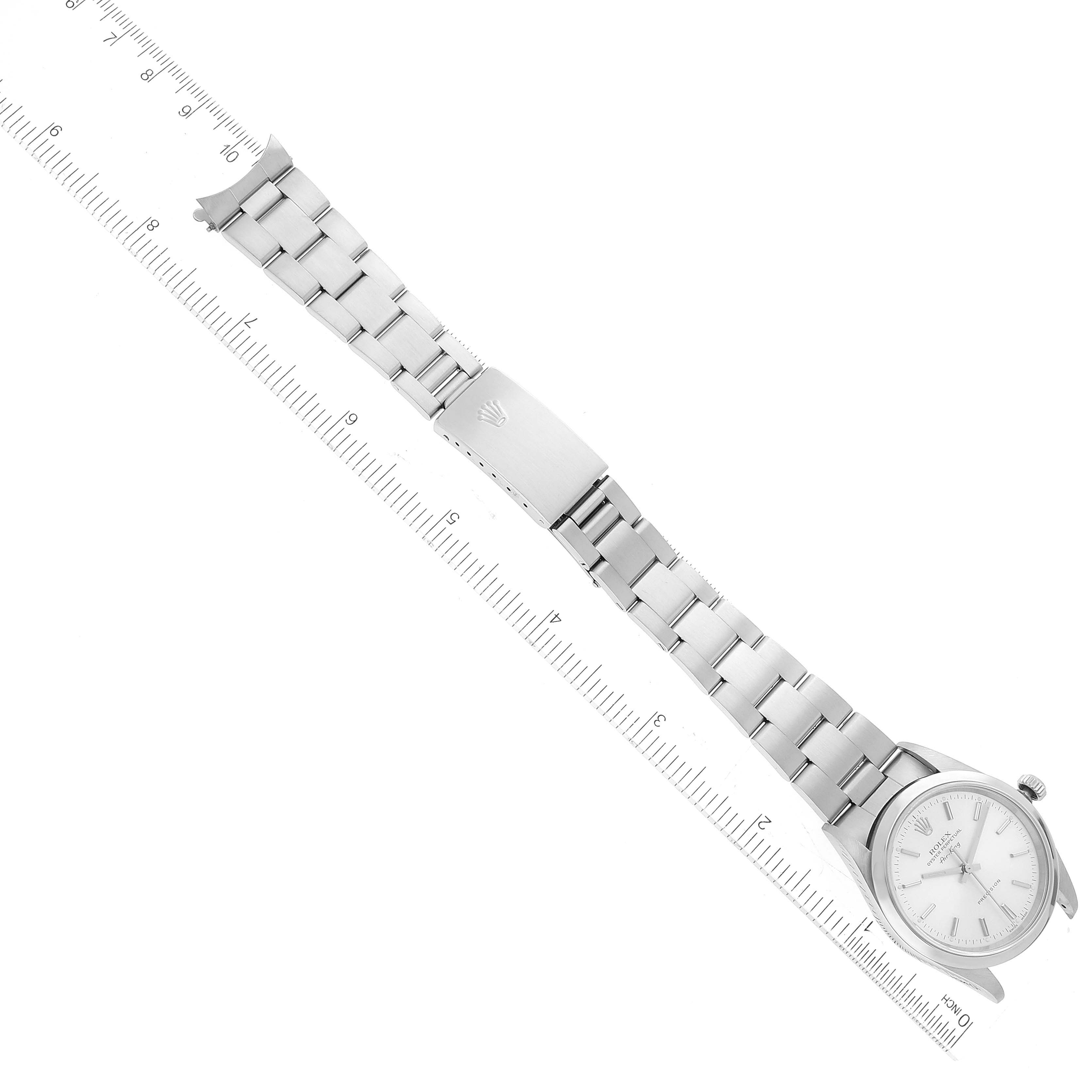 The image displays a top view of the Rolex Air-King 14000 Men's Stainless Steel Silver Dial 14000 Men's Stainless Steel Silver Dial watch including its bracelet, clasp, and face, aligned with a ruler for scale.