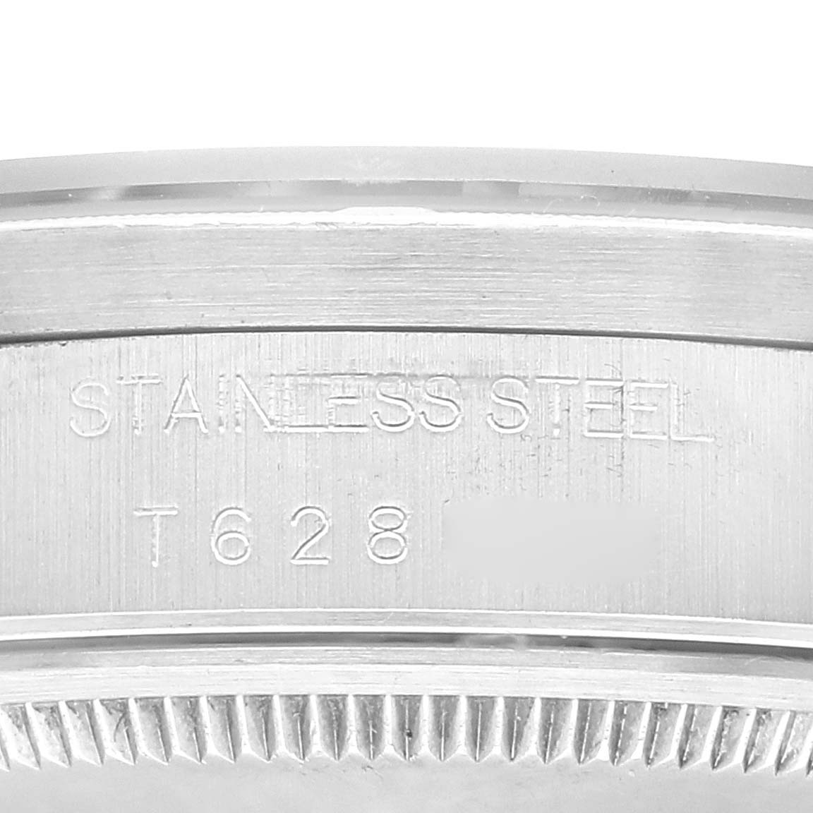 This close-up image of the Rolex Air-King 14010 Men's Stainless Steel Black Dial 14010 Men's Stainless Steel Black Dial model shows the engraving on the stainless steel case side, displaying the model and serial numbers.