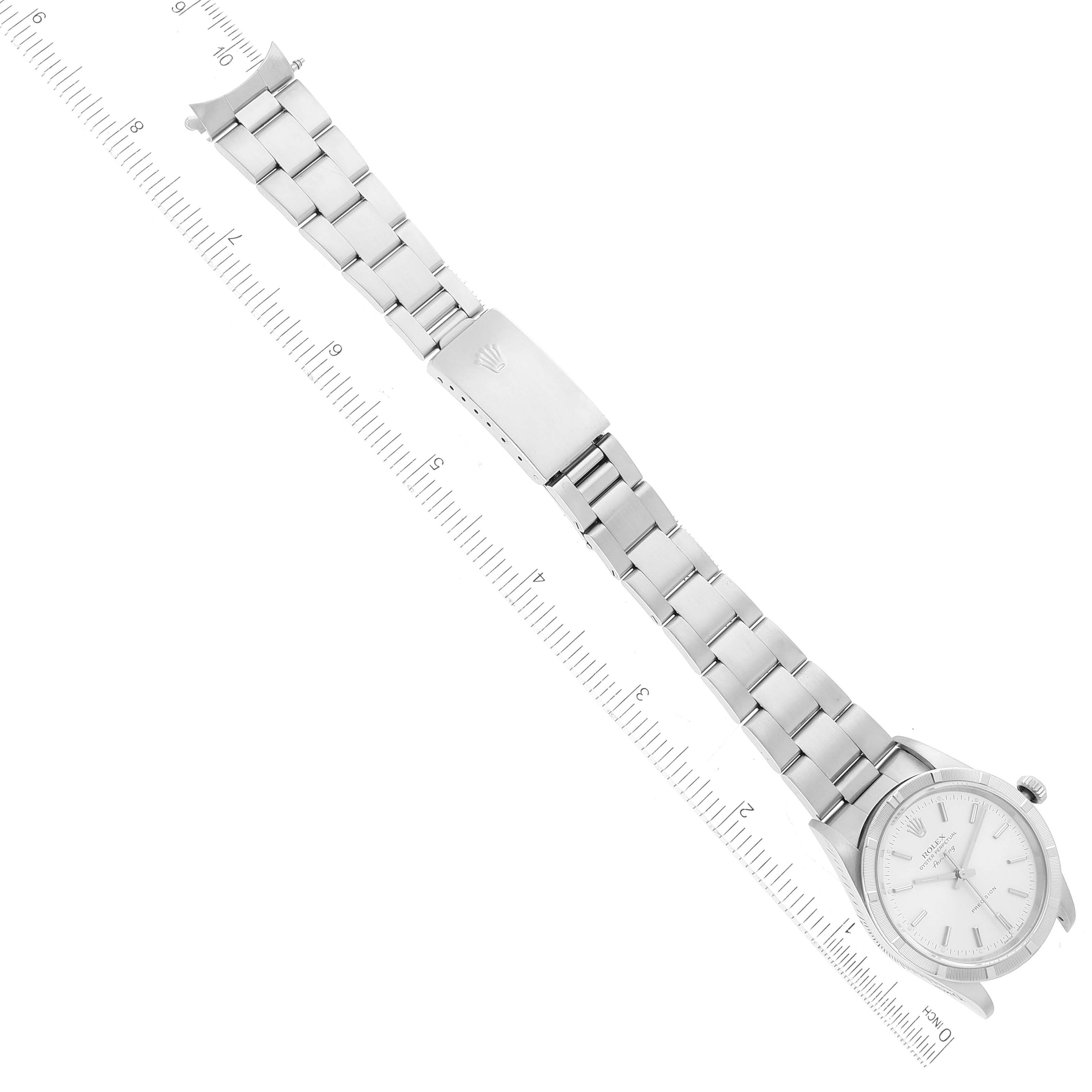The image shows a flat-laid Rolex Air-King 14010 Men's Stainless Steel Silver Dial 14010 Men's Stainless Steel Silver Dial watch with a clear view of its face, bracelet, and clasp, alongside a measuring scale.