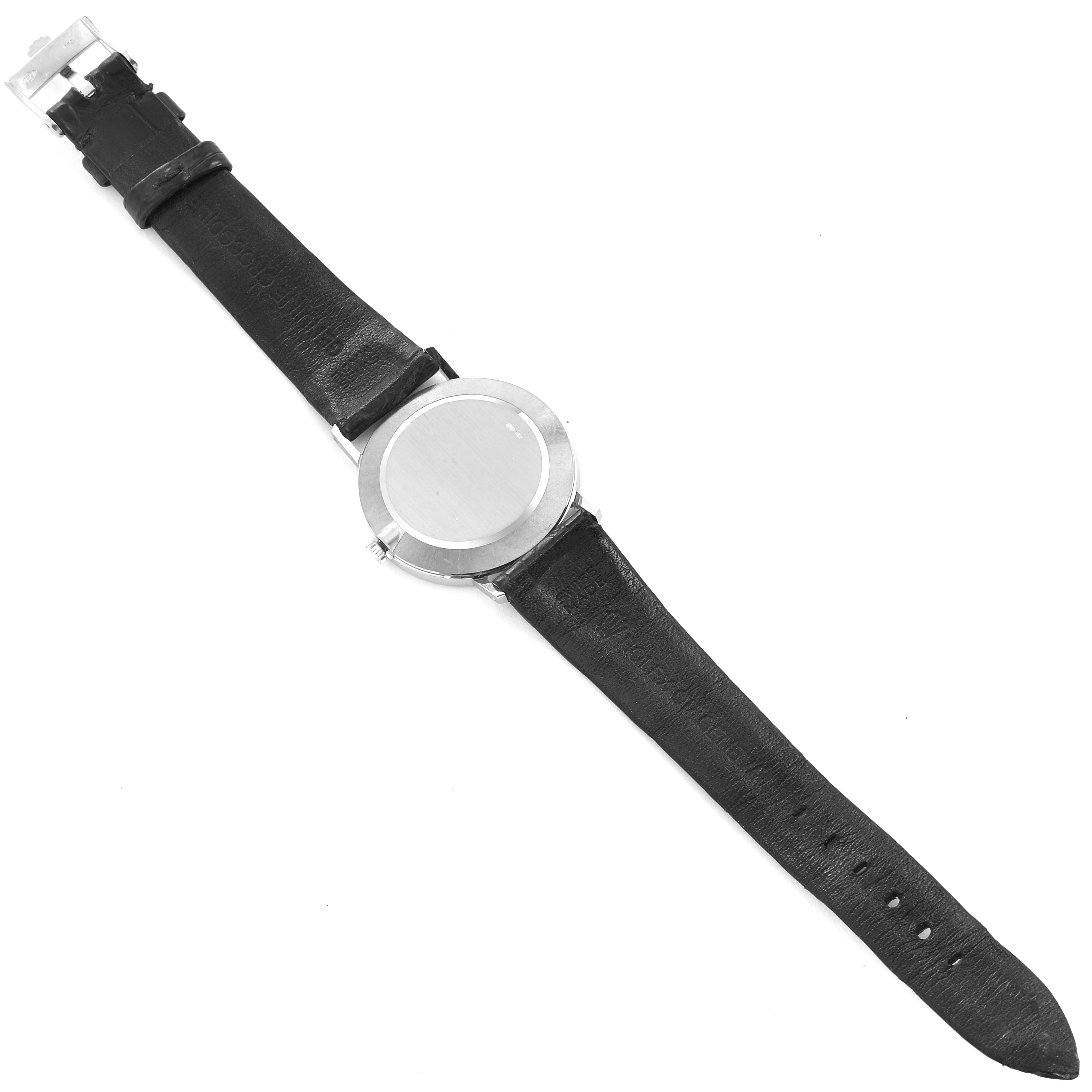 The image shows the back of a Cellini model by Rolex, including its black leather strap and the stainless steel case back.