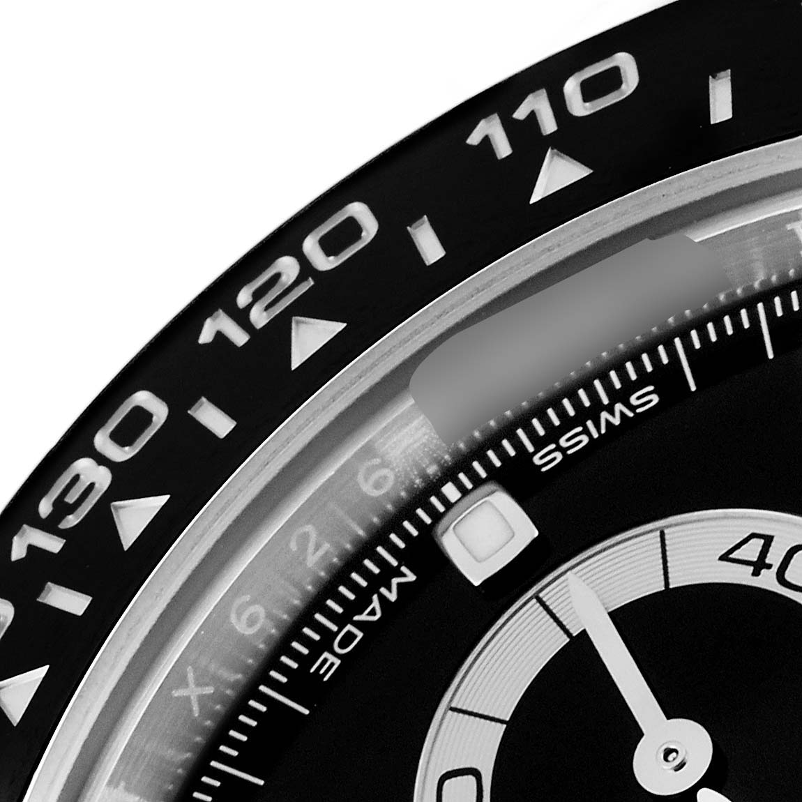This image shows a close-up of the bezel and part of the dial of a Rolex Daytona 116500 Men's Stainless Steel Black Dial 116500 Men's Stainless Steel Black Dial watch, highlighting the tachymeter scale.