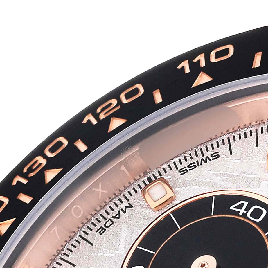 This close-up of the Rolex Daytona 116515LN Men's Rose Gold Silver Dial 116515LN Men's Rose Gold Silver Dial watch showcases part of the bezel with tachymeter scale and a portion of the dial.