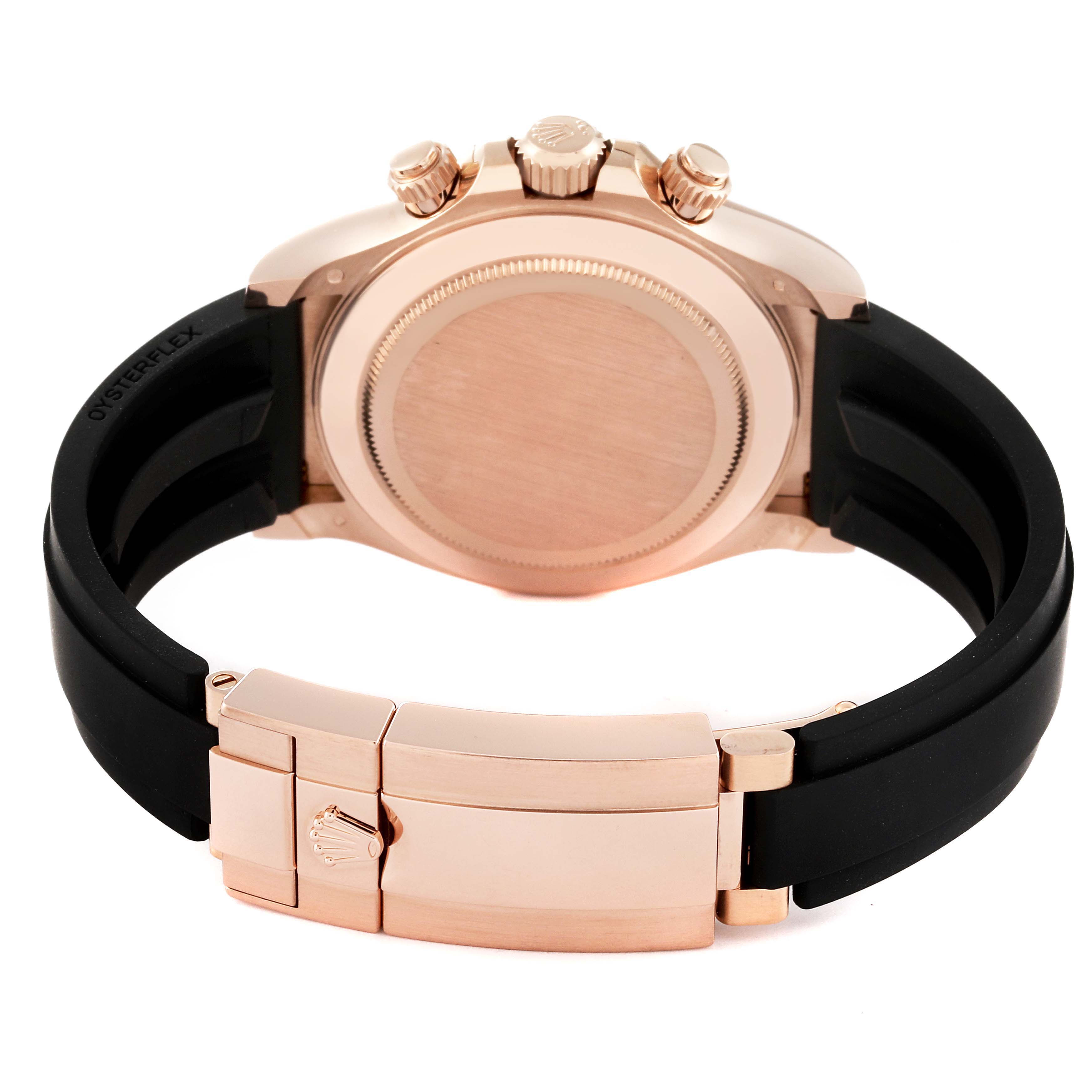 The image shows the back of a Rolex Daytona 116515LN Men's Rose Gold Silver Dial 116515LN Men's Rose Gold Silver Dial watch with a rose gold case and a black Oysterflex bracelet.