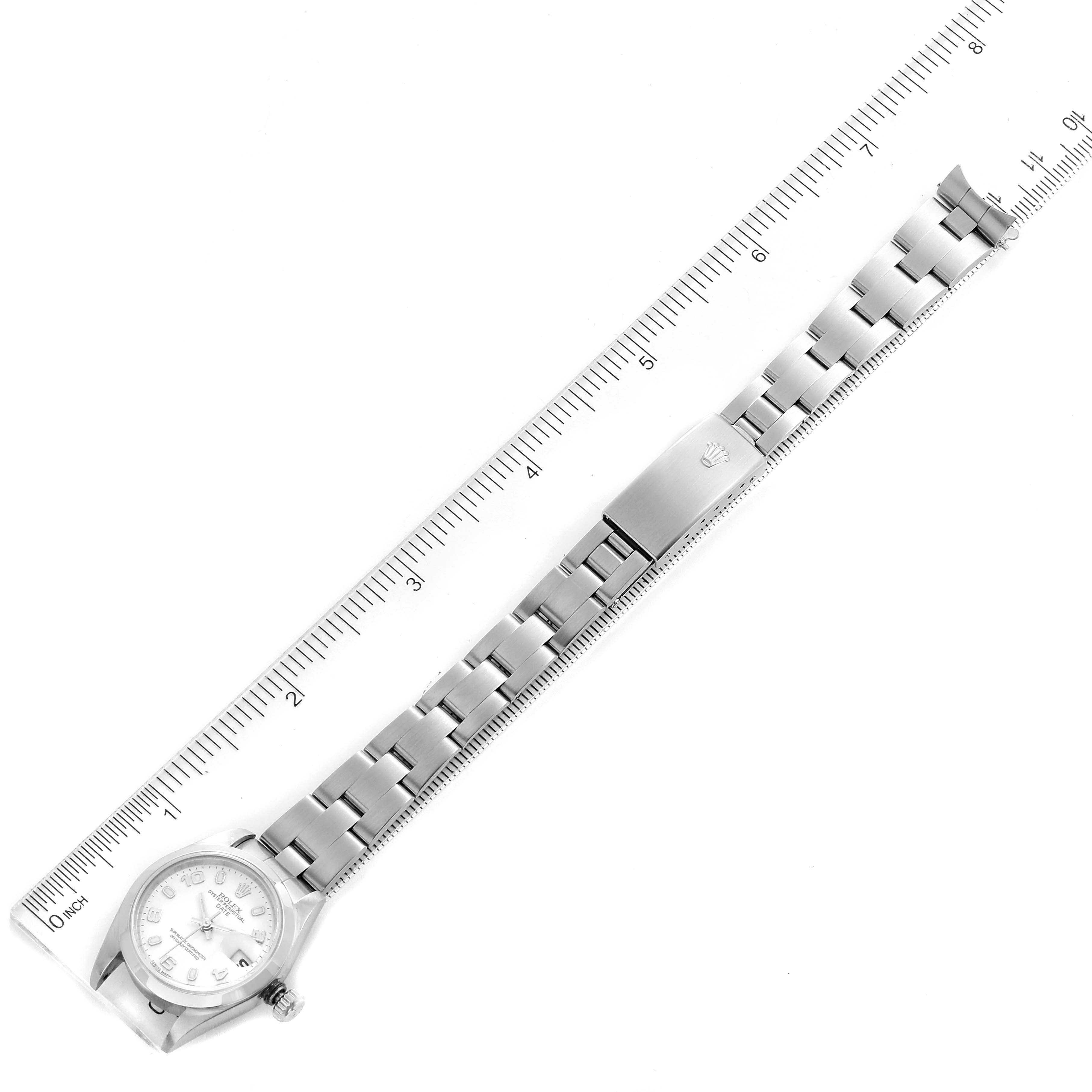 The image shows a Rolex Date 79160 Women's Stainless Steel White Dial 79160 Women's Stainless Steel White Dial model watch from a top-down angle, highlighting the full bracelet and dial alongside a ruler for scale.
