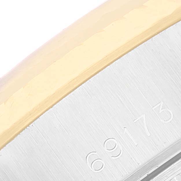 This image shows a close-up of the side of a Rolex Datejust 69173 Women's Steel and Gold (two tone) Champagne Dial 69173 Women's Steel and Gold (two tone) Champagne Dial watch case with the model number "69173" engraved.