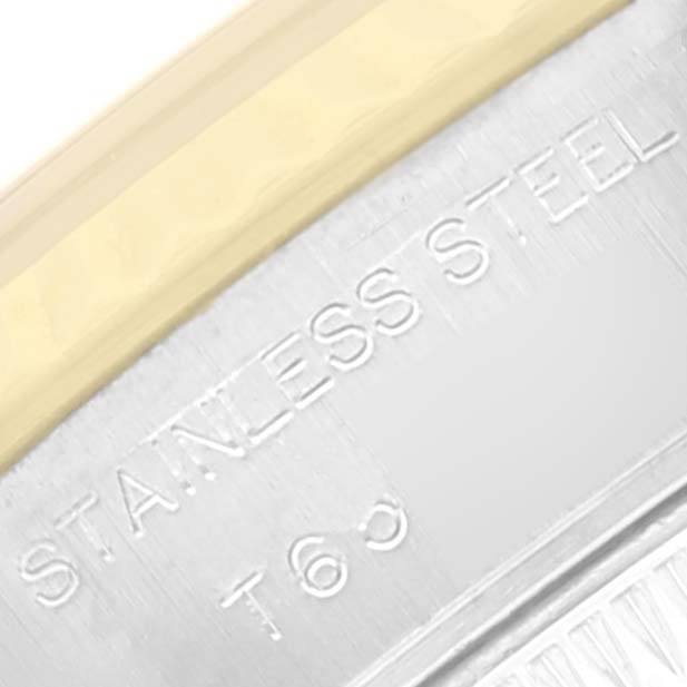 The image shows a close-up angle of the letter engravings on the stainless steel part of a Rolex Datejust 69173 Women's Steel and Gold (two tone) Champagne Dial 69173 Women's Steel and Gold (two tone) Champagne Dial watch.