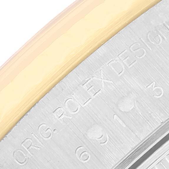 The image shows a close-up of the engraving on the bezel and case of a Rolex Datejust 69173 Women's Steel and Gold (two tone) Champagne Dial 69173 Women's Steel and Gold (two tone) Champagne Dial watch.