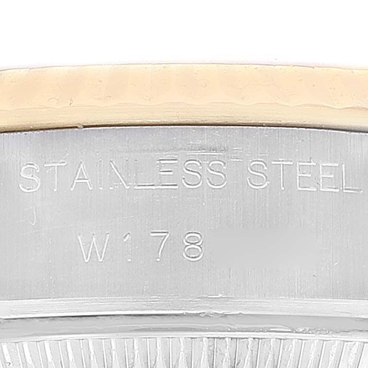 This is a close-up of the side of a Rolex Datejust 69173 Women's Steel and Gold (two tone) Champagne Dial 69173 Women's Steel and Gold (two tone) Champagne Dial watch showcasing the stainless steel marking and partial serial number.