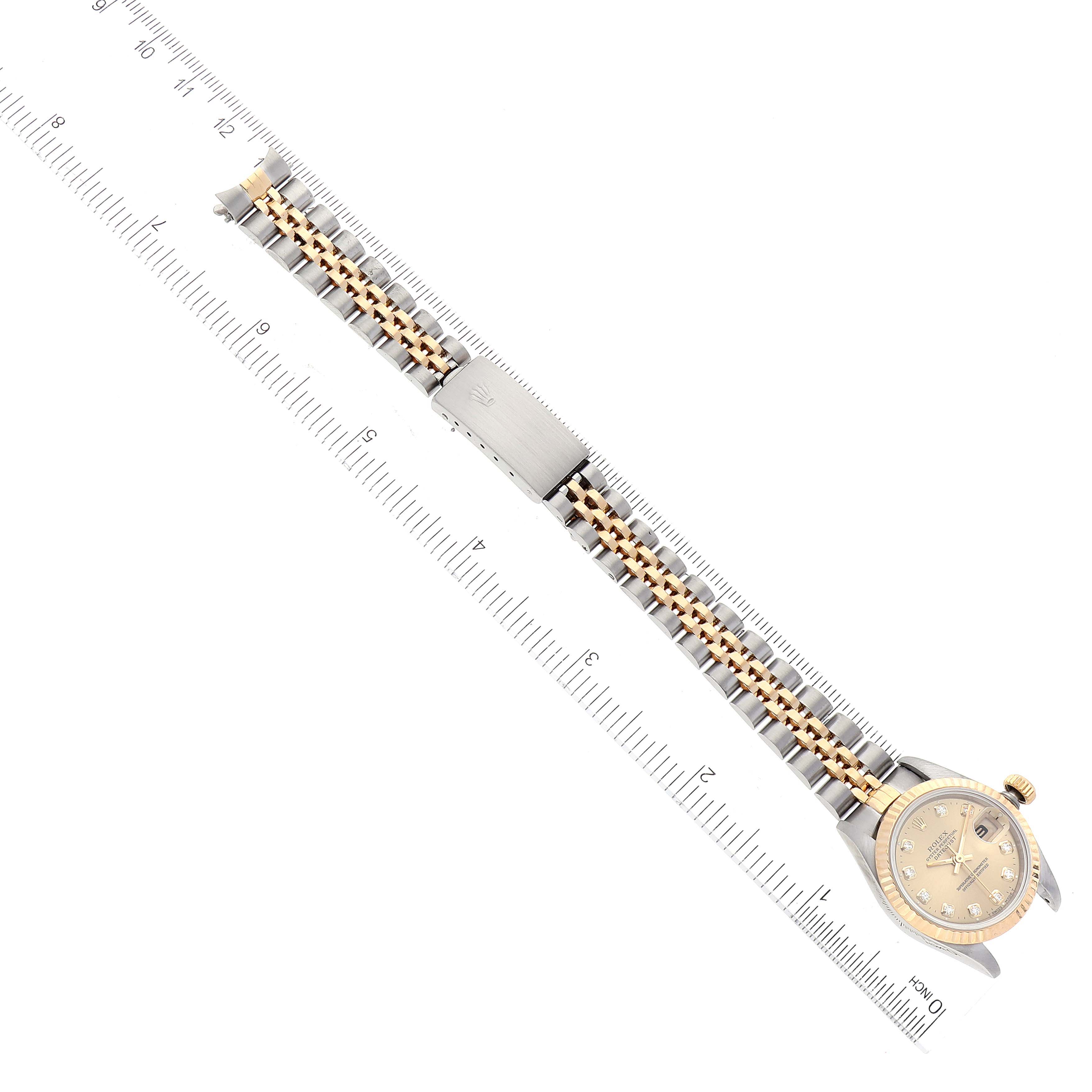 The image shows a top-down view of the Rolex Datejust 69173 Women's Steel and Gold (two tone) Champagne Dial 69173 Women's Steel and Gold (two tone) Champagne Dial watch, highlighting the band, clasp, and the watch face.