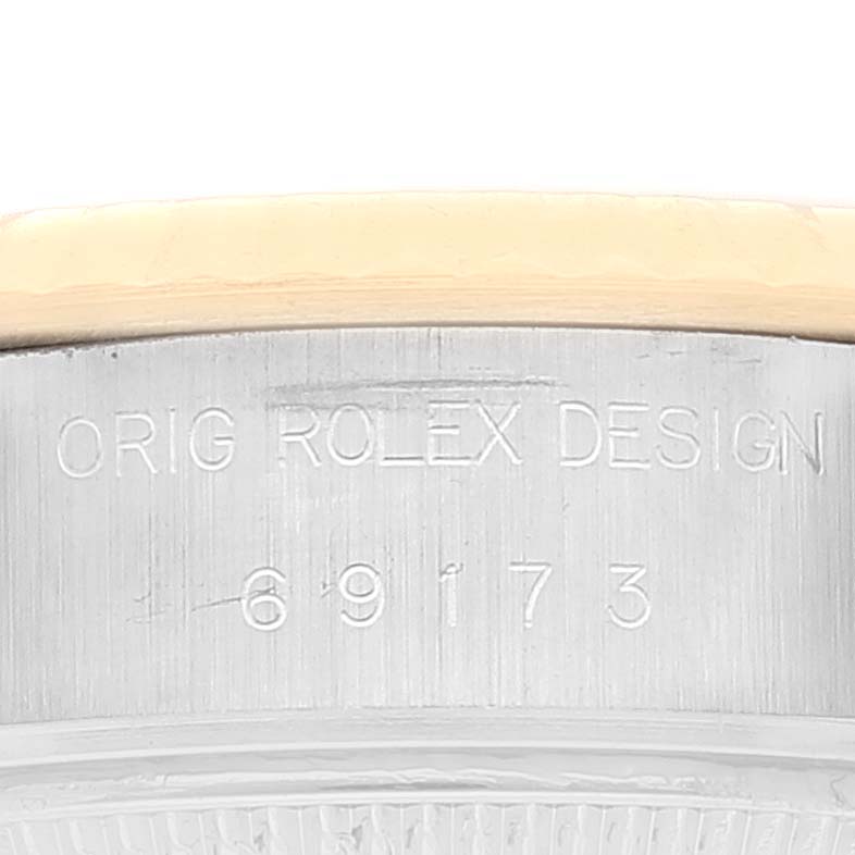 This image shows a close-up of the case side of a Rolex Datejust 69173 Women's Steel and Gold (two tone) Champagne Dial 69173 Women's Steel and Gold (two tone) Champagne Dial, revealing the model number and "ORIG ROLEX DESIGN" engraving.