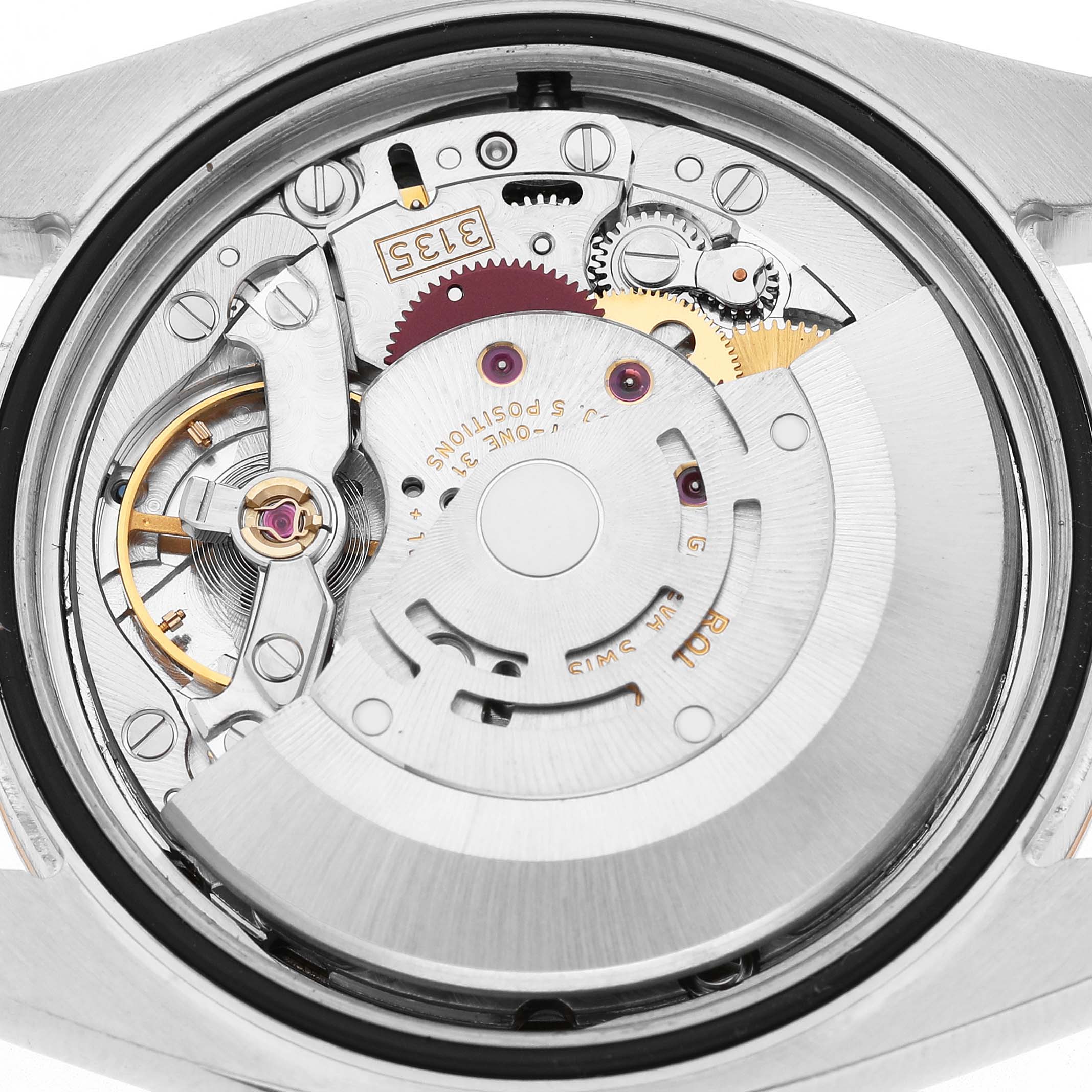 The image shows the movement of a Rolex Datejust 116231 Men's Steel and Gold (two tone) Black Dial from a rear angle, highlighting its intricate gears and rotor.