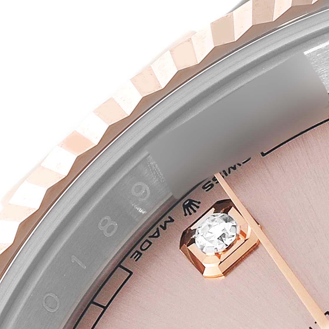 This close-up image of the Rolex Datejust 41 126331 Men's Steel and Gold (two tone) Beige Dial 126331 Men's Steel and Gold (two tone) Beige Dial shows the fluted bezel, part of the watch face, and a diamond hour marker.