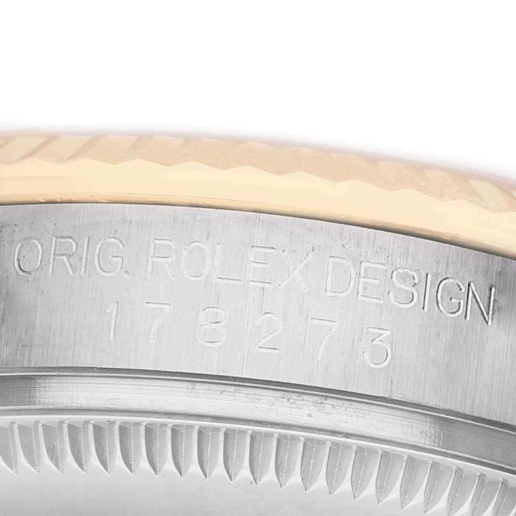 The image shows a close-up of the side of a Rolex Mid-Size 178273 Women's Steel and Gold (two tone) Champagne Dial watch, focusing on the engraved details.
