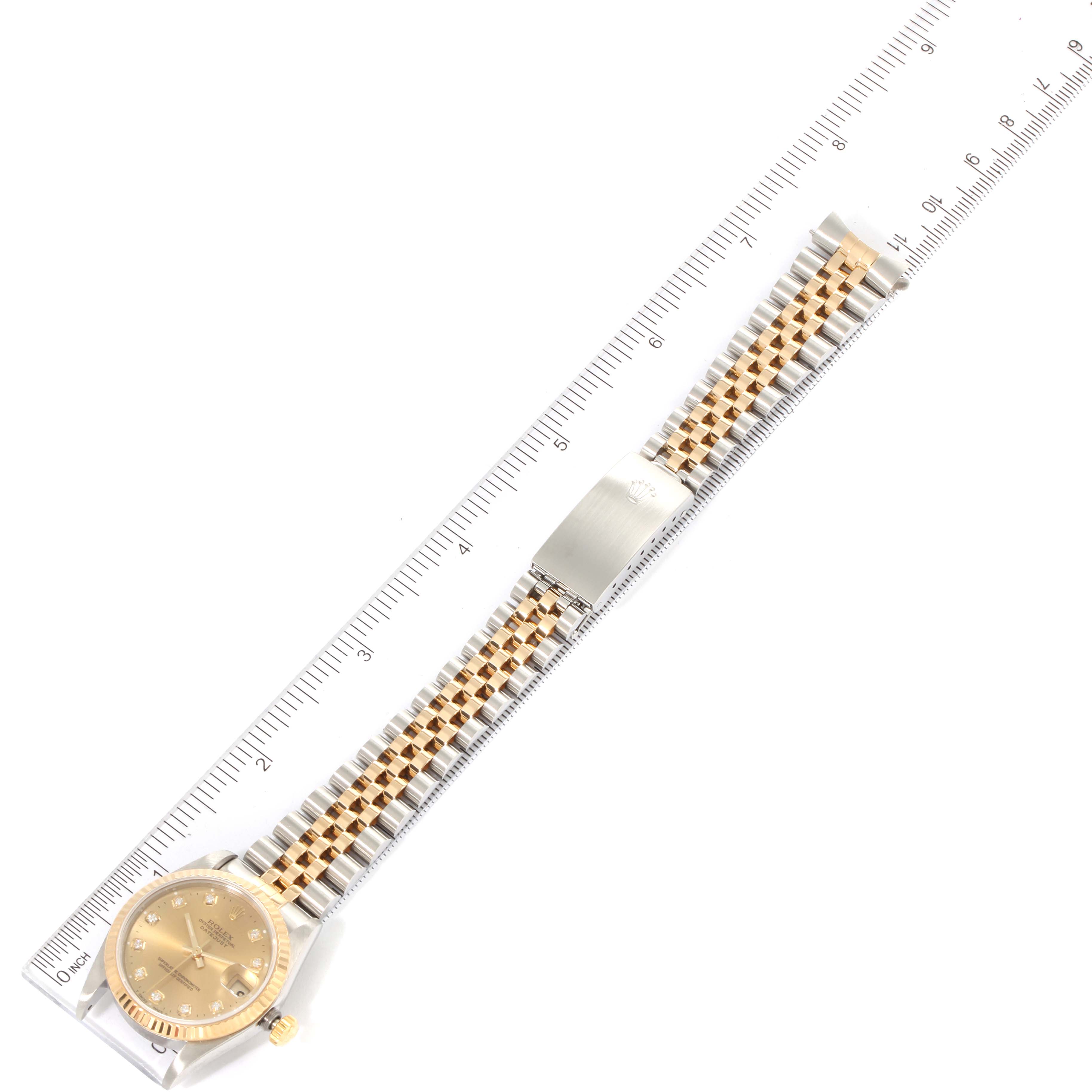 This image shows a Rolex Mid-Size 68273 Women's Steel and Gold (two tone) Champagne Dial 68273 Women's Steel and Gold (two tone) Champagne Dial model watch laid flat with its dial, bracelet, and clasp fully visible next to a ruler.
