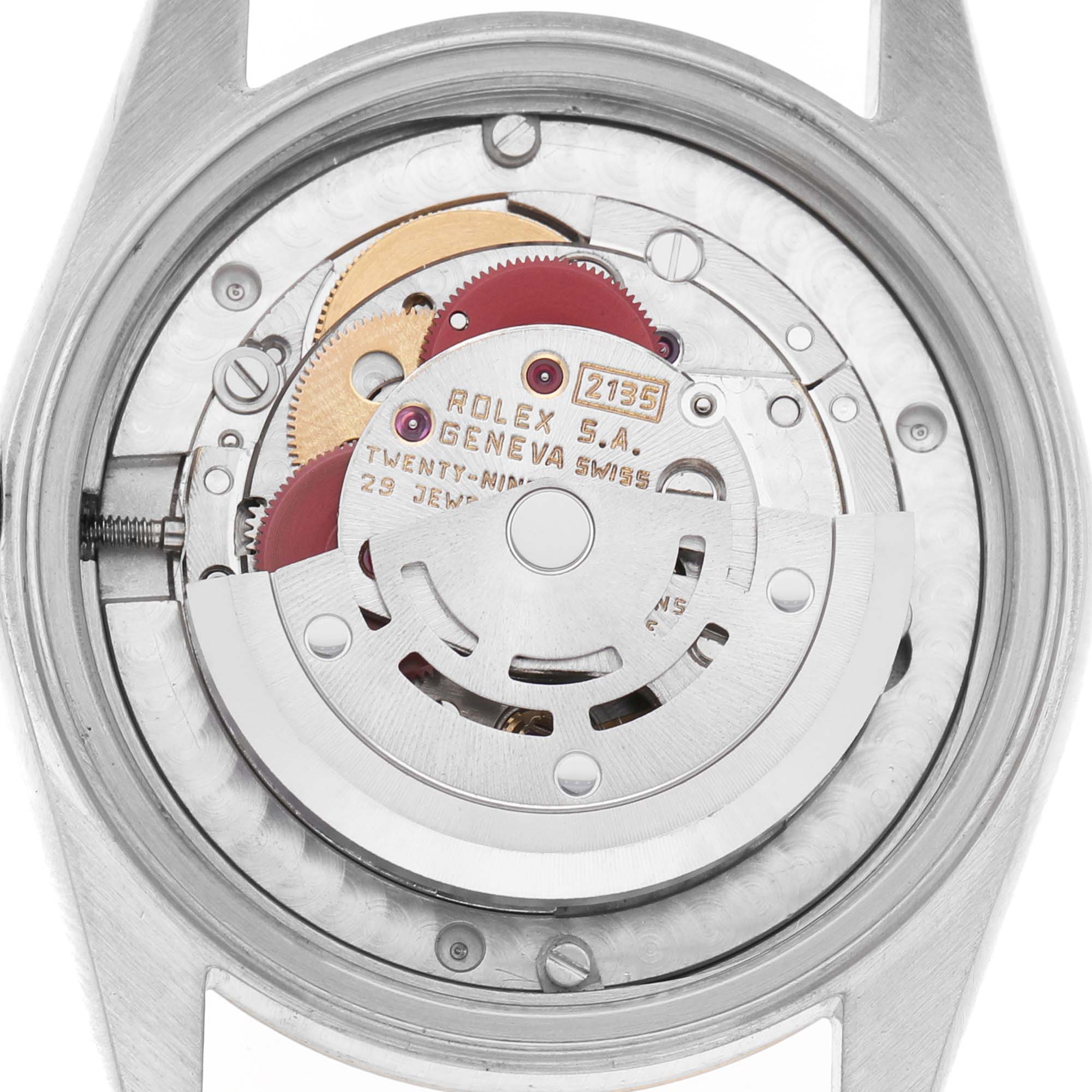 The image shows the back view of a mid-size Rolex watch, revealing its internal movement components.