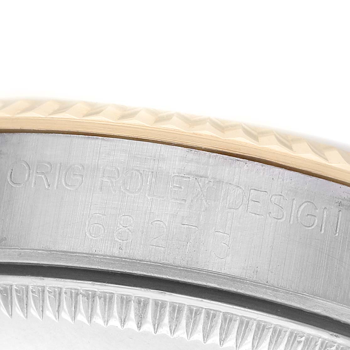 The image shows a close-up of the engraved side of a Mid-Size Rolex watch case with a fluted bezel.