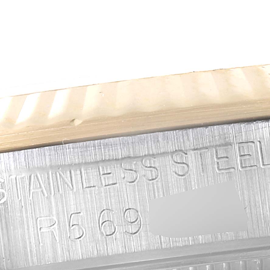 This close-up image shows the serial number and "Stainless Steel" engraving on the case of a Rolex Mid-Size 68273 Women
s Steel and Gold (two tone) White Dial 68273 Women
s Steel and Gold (two tone) White Dial model.