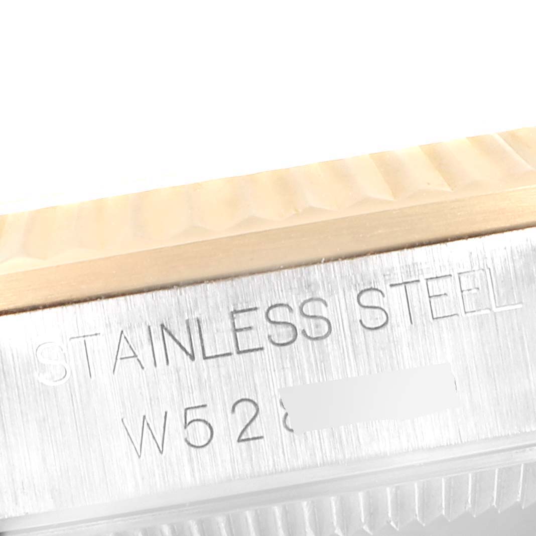 This close-up shows the stainless steel and partially obscured serial number of the Mid-Size Rolex watch.