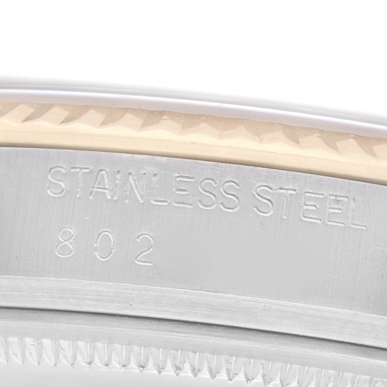 The image shows a close-up of the bezel and case edge of a Rolex Datejust model 16013, highlighting the "STAINLESS STEEL 802" engraving.