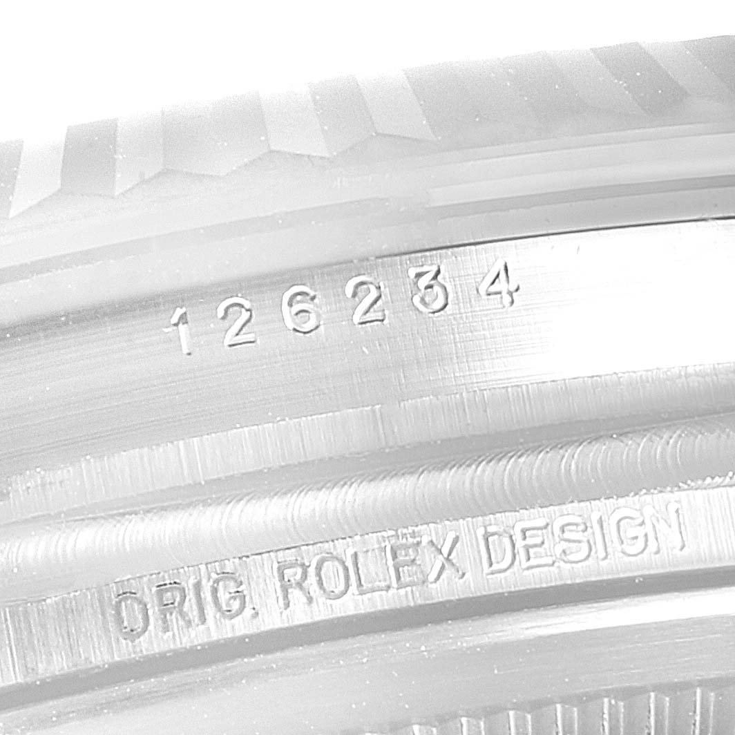 The image shows the engraved serial number on the case back of a Rolex Datejust 126234 Men's Stainless Steel Silver Dial 126234 Men's Stainless Steel Silver Dial watch, viewed up close.
