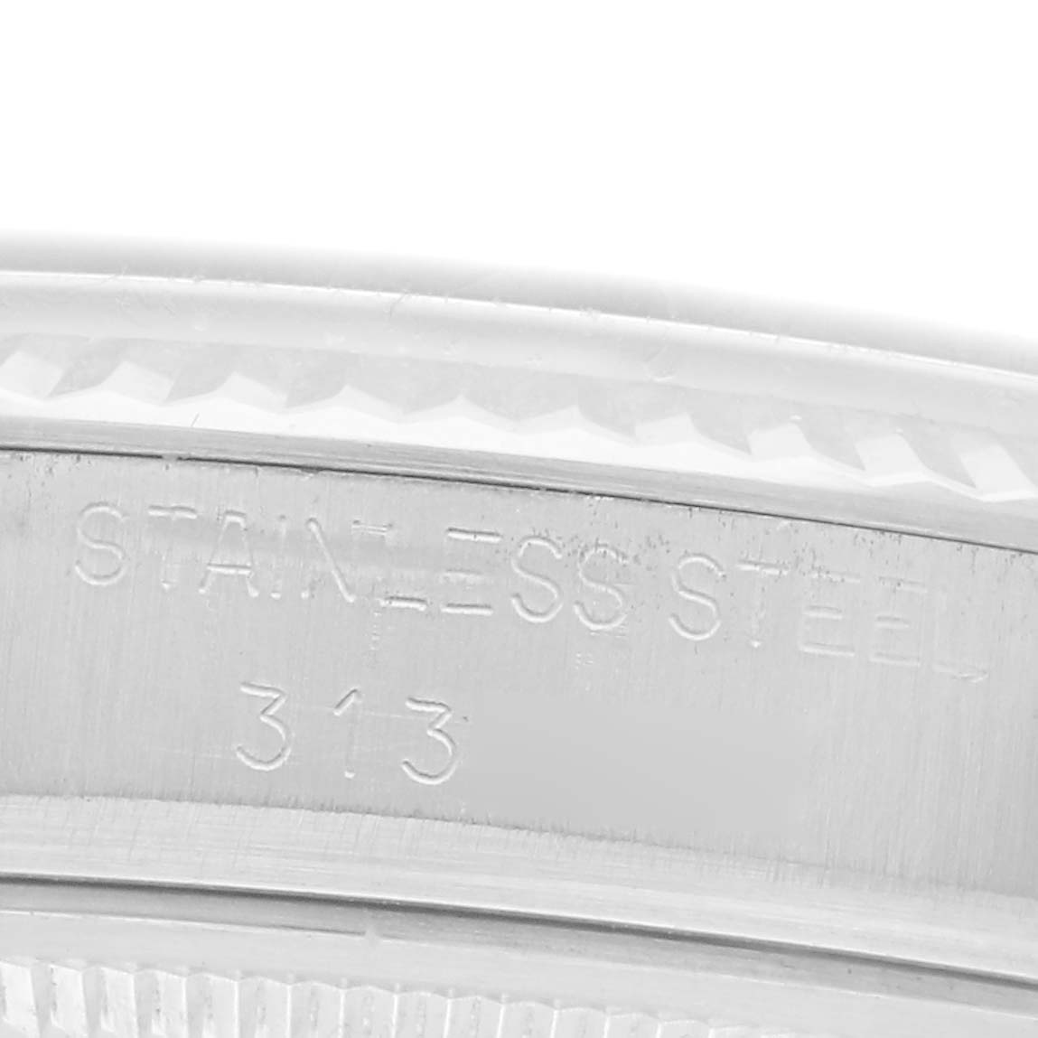 The image shows a close-up of the inner bezel of the Rolex Vintage Collection model, model number 1601, displaying engraved markings on stainless steel.