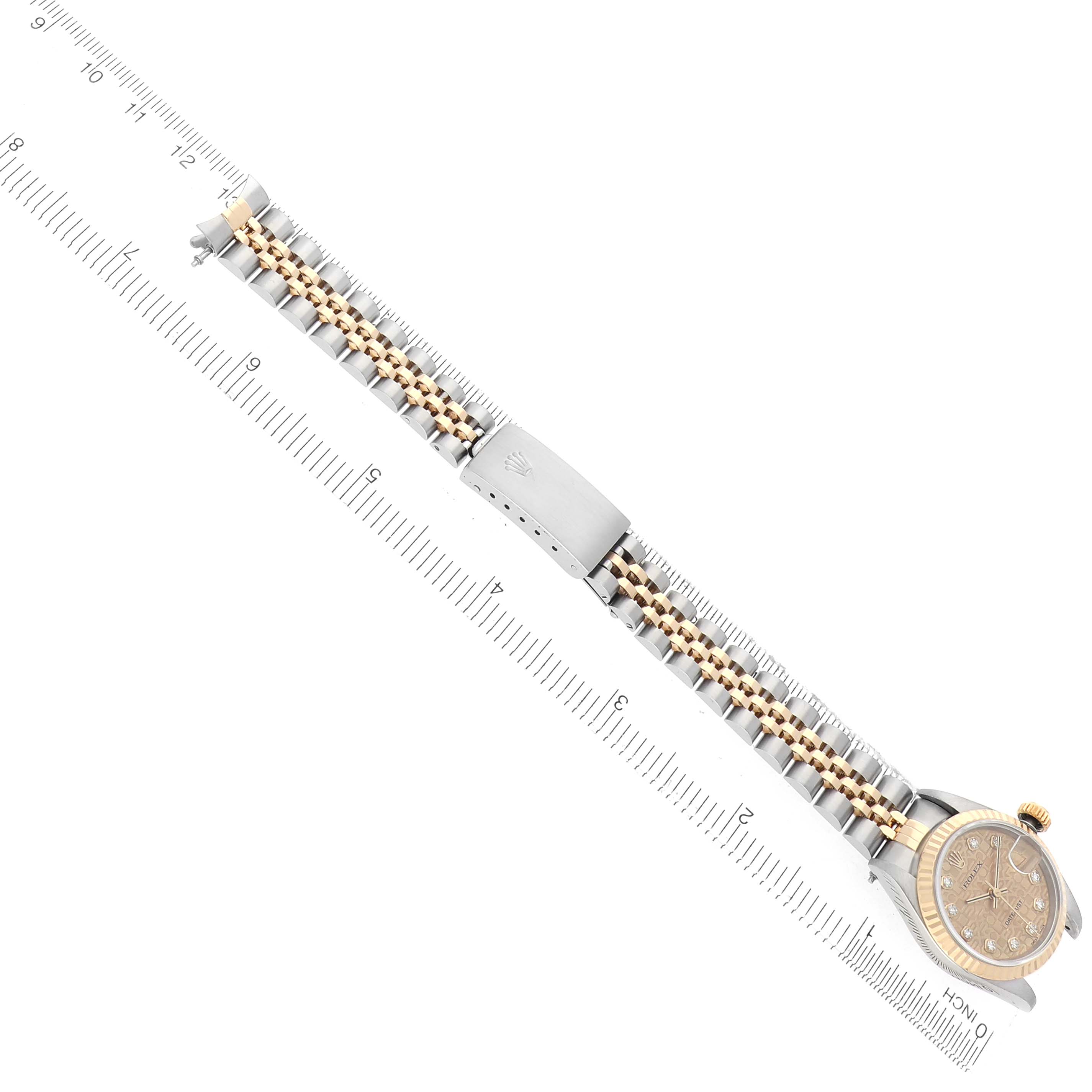 The Rolex Datejust model 79173 watch is shown from a top-down angle, highlighting the bracelet and partially visible watch face.