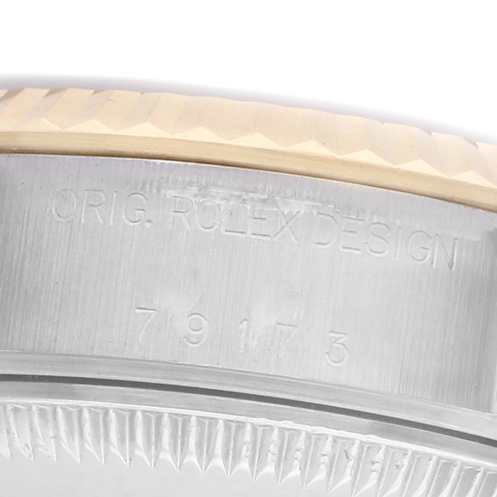 The image shows a close-up side view of the Rolex Datejust model number 79173, focusing on the engraved model number and bezel detail.