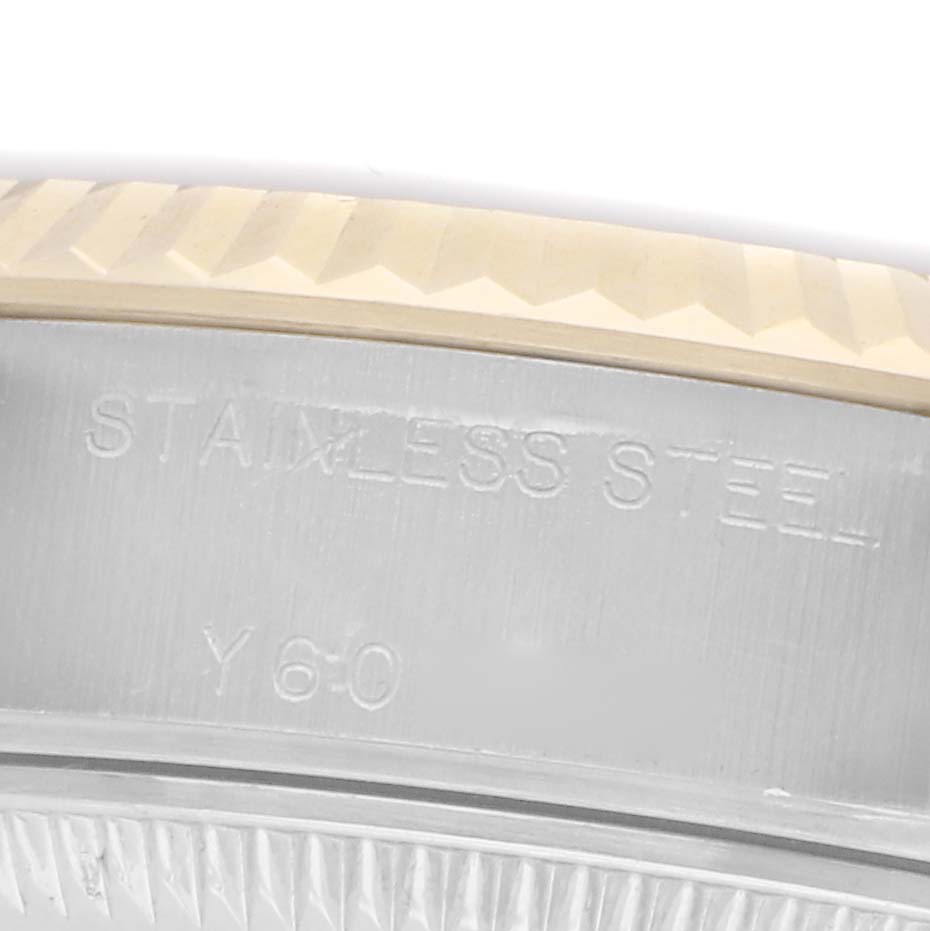 The image shows a close-up of the side of a Rolex Datejust 79173, displaying "STAINLESS STEEL" engraving on the metal surface near the bezel.