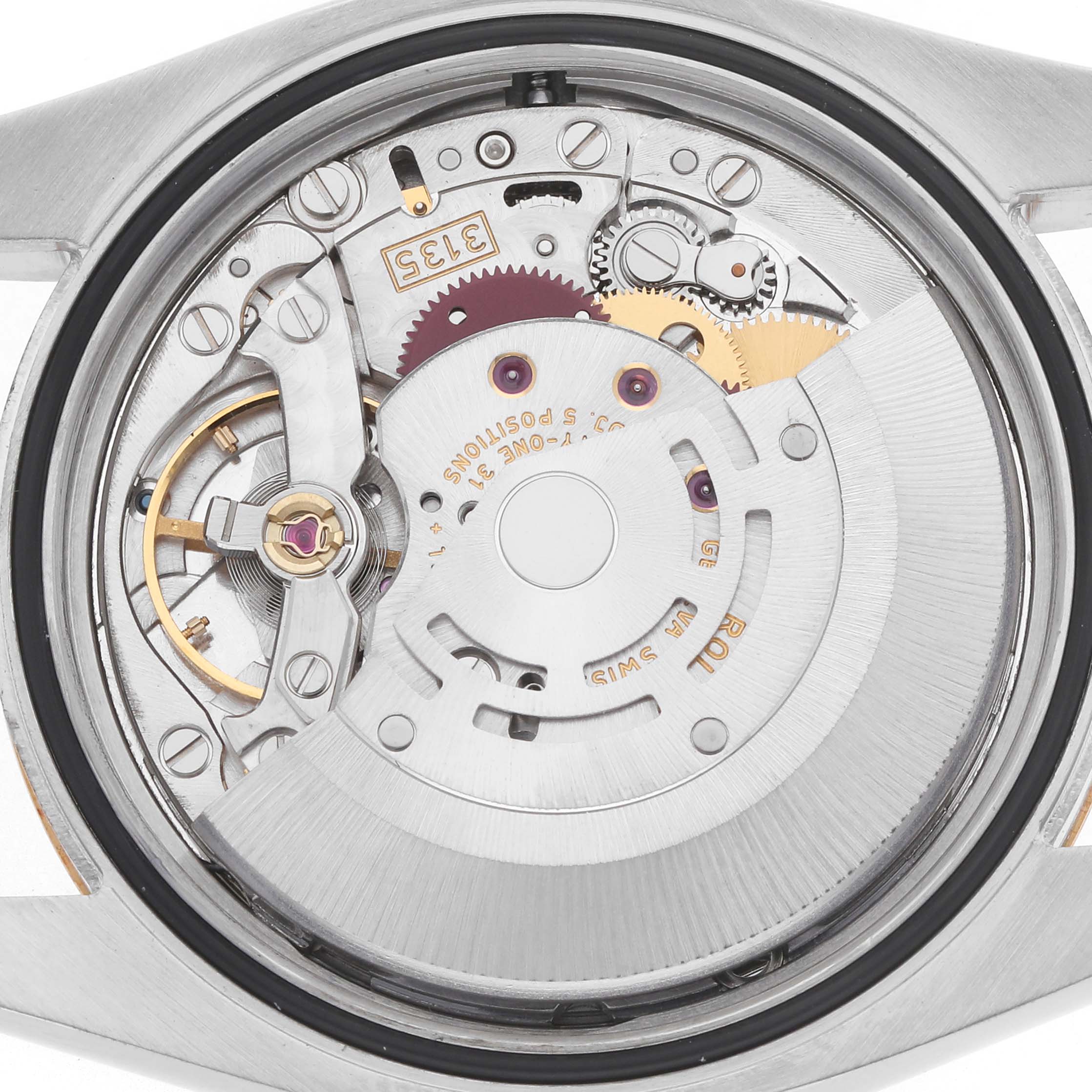 The image shows an overhead view of the movement of a Rolex Datejust model 116233, highlighting its intricate gears and components.