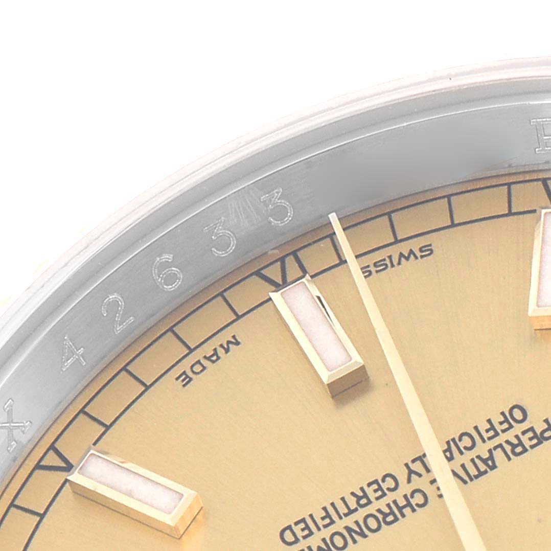 The close-up image of the Rolex Datejust model 116233 shows part of the dial, bezel edge, and a few hour markers.