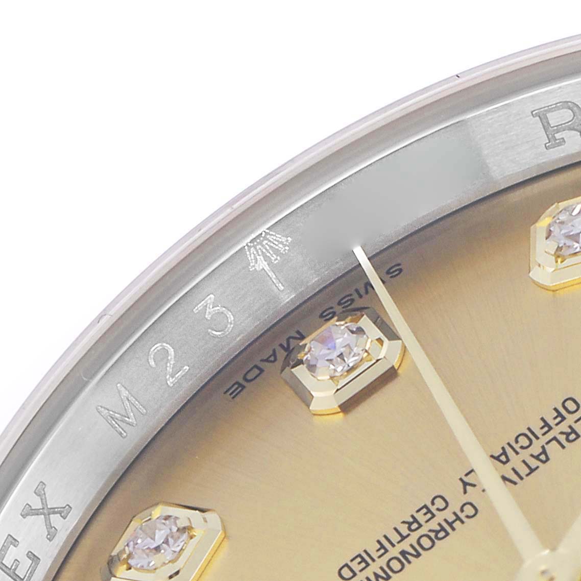 The image shows a close-up of the dial on the Rolex Datejust model 116233, highlighting the polished bezel, part of the dial, and diamond hour markers.