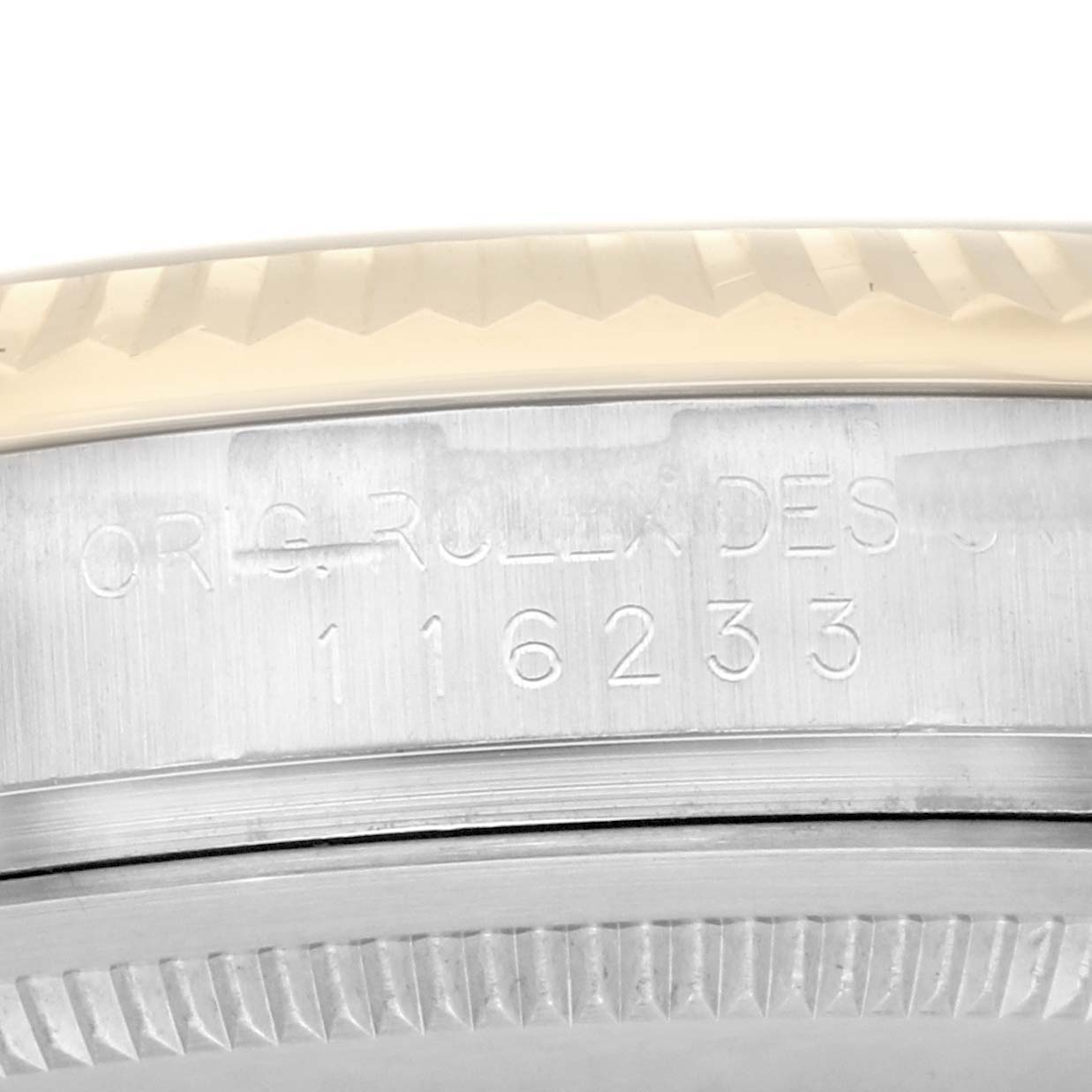 The image shows a close-up of the side engraving on a Rolex Datejust men
s watch, model number 116233, revealing its fluted bezel and serial number.