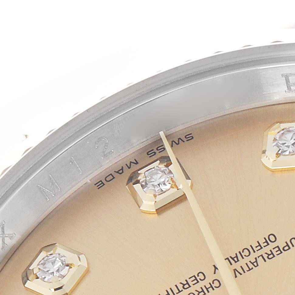 The image shows a close-up of the dial and bezel of the Rolex Datejust model 116233, highlighting the diamond hour markers and part of the minute hand.