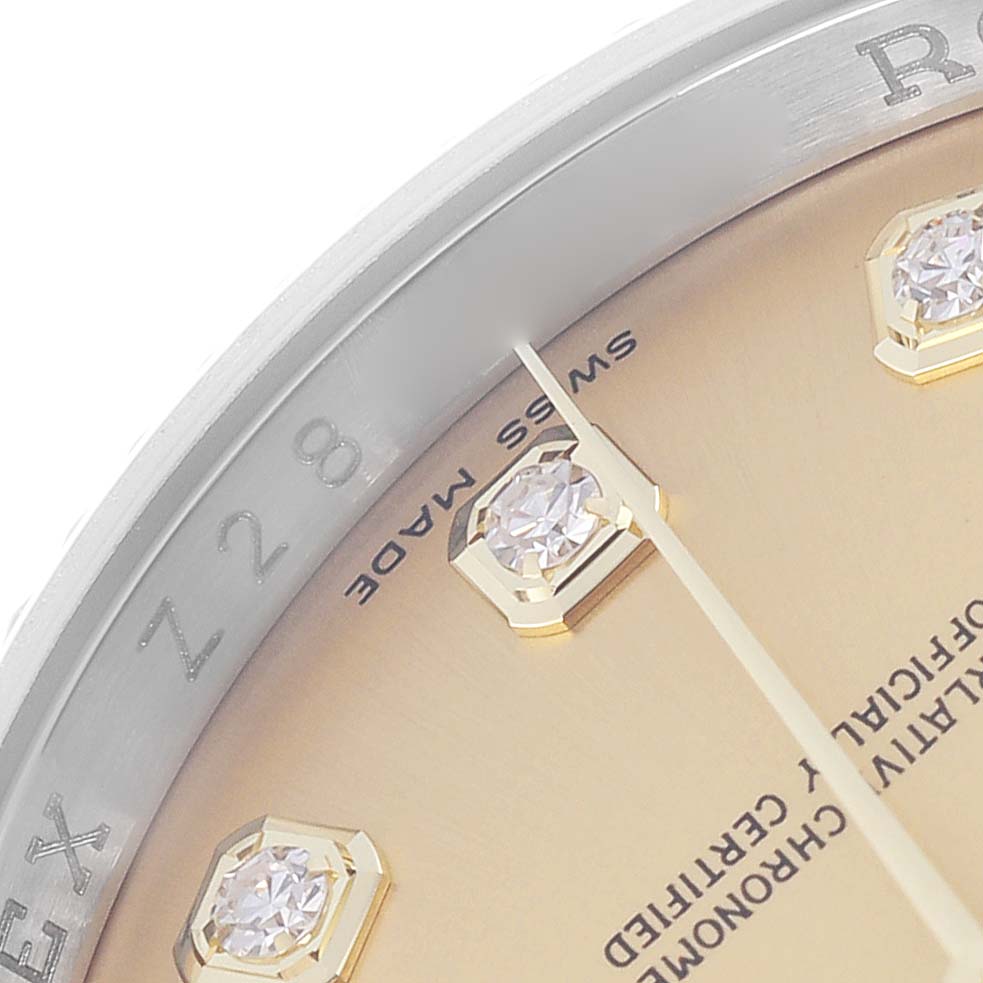 The image shows a close-up of the dial and bezel of a Rolex Datejust model 116233, featuring diamond hour markers and part of the gold-tone face.