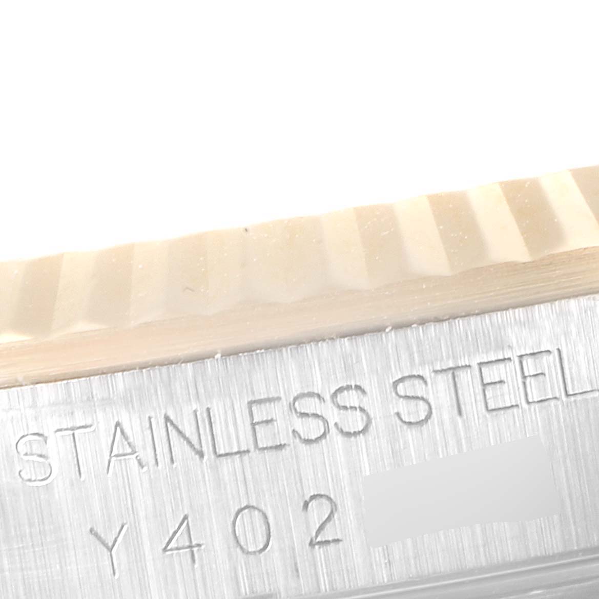 This close-up image shows the fluted bezel and part of the case engraving on a Rolex Datejust 16233 Men's Steel and Gold (two tone) Champagne Dial 16233 Men's Steel and Gold (two tone) Champagne Dial watch.